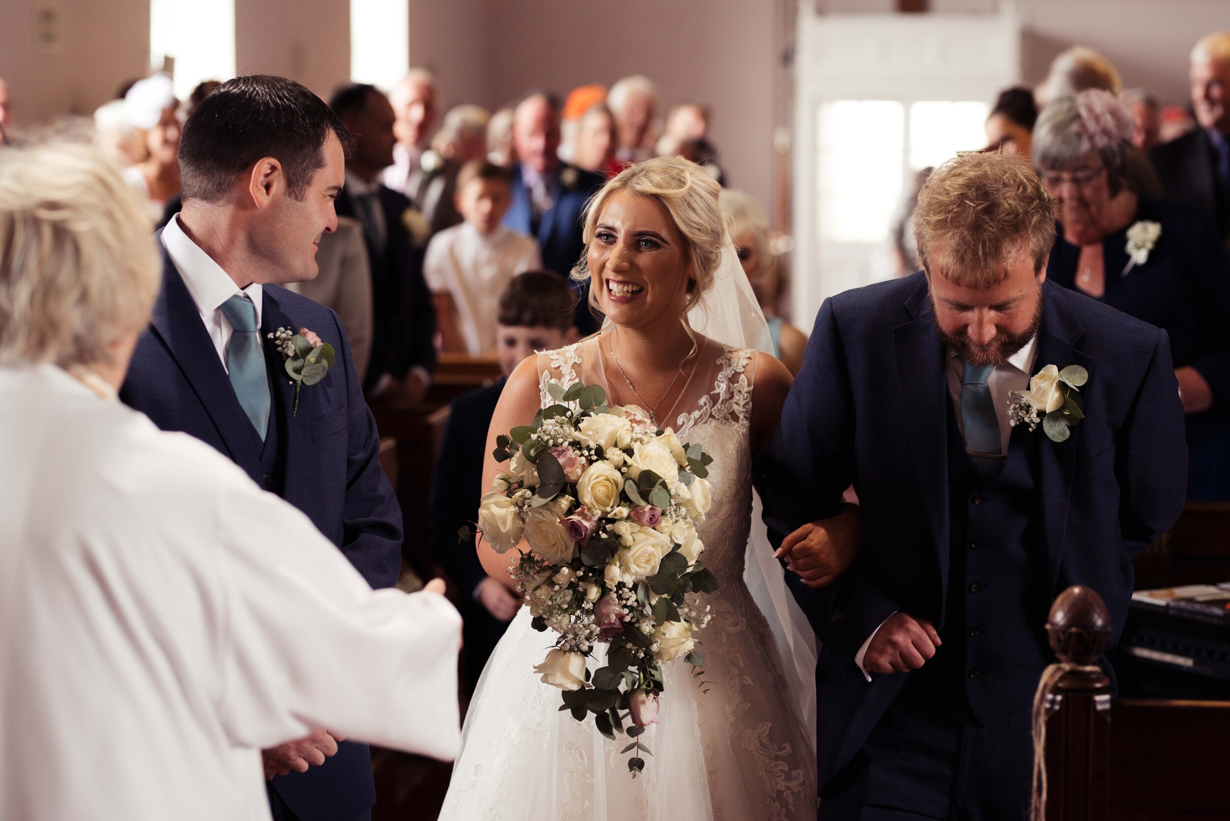 Bride sees her smiling groom for the first time in the church