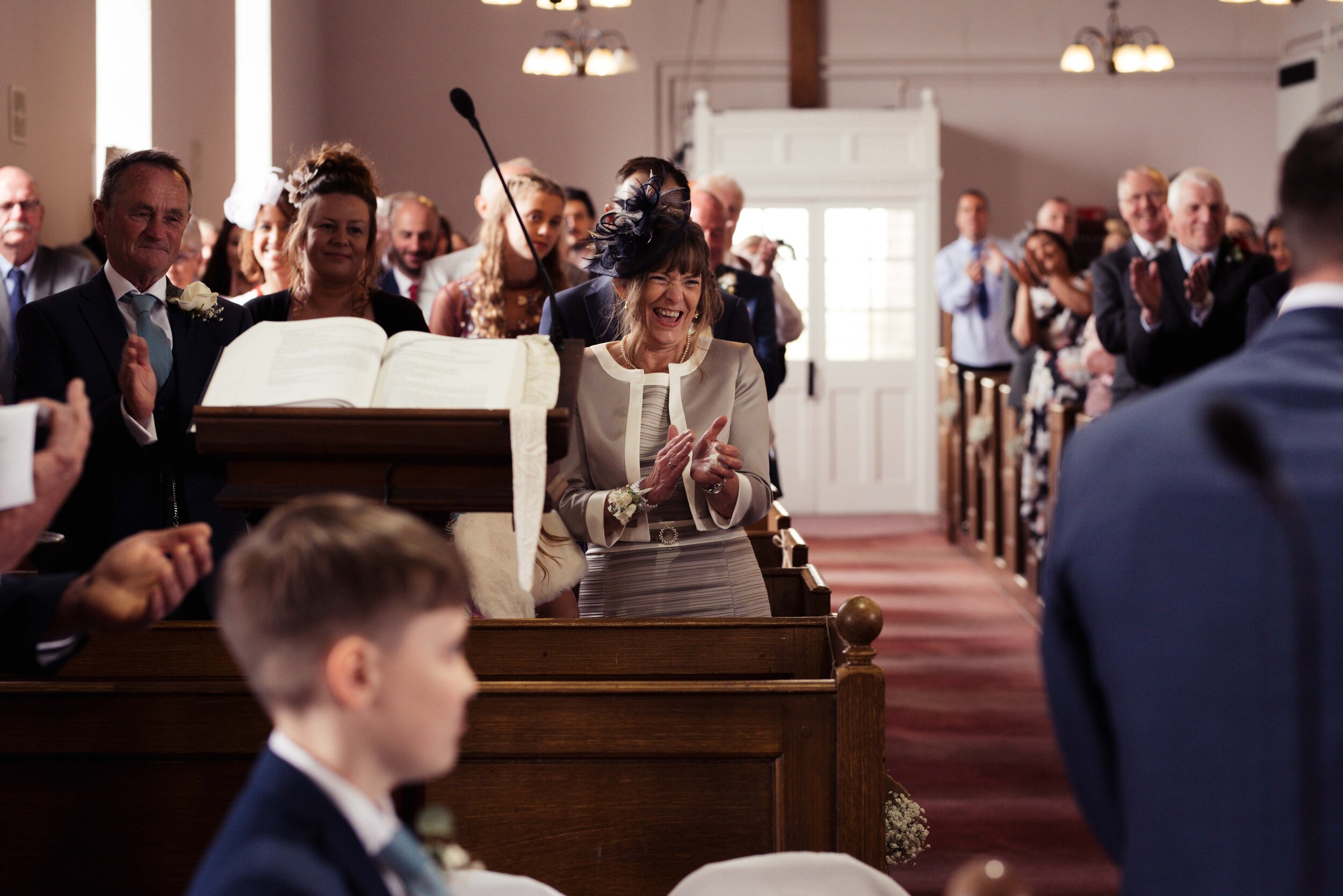 Mother of the groom looks excited during the wedding service