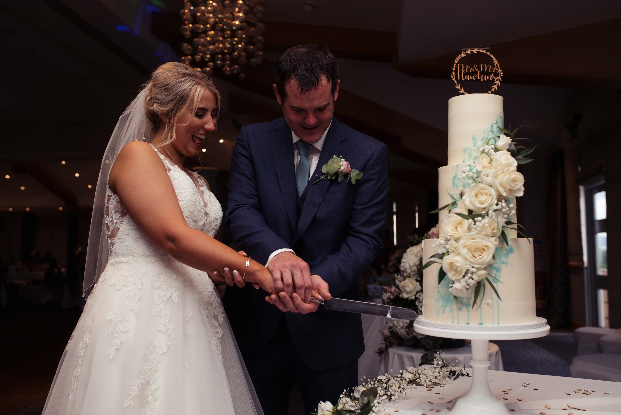 The bride and groom cut their gorgeous wedding cake