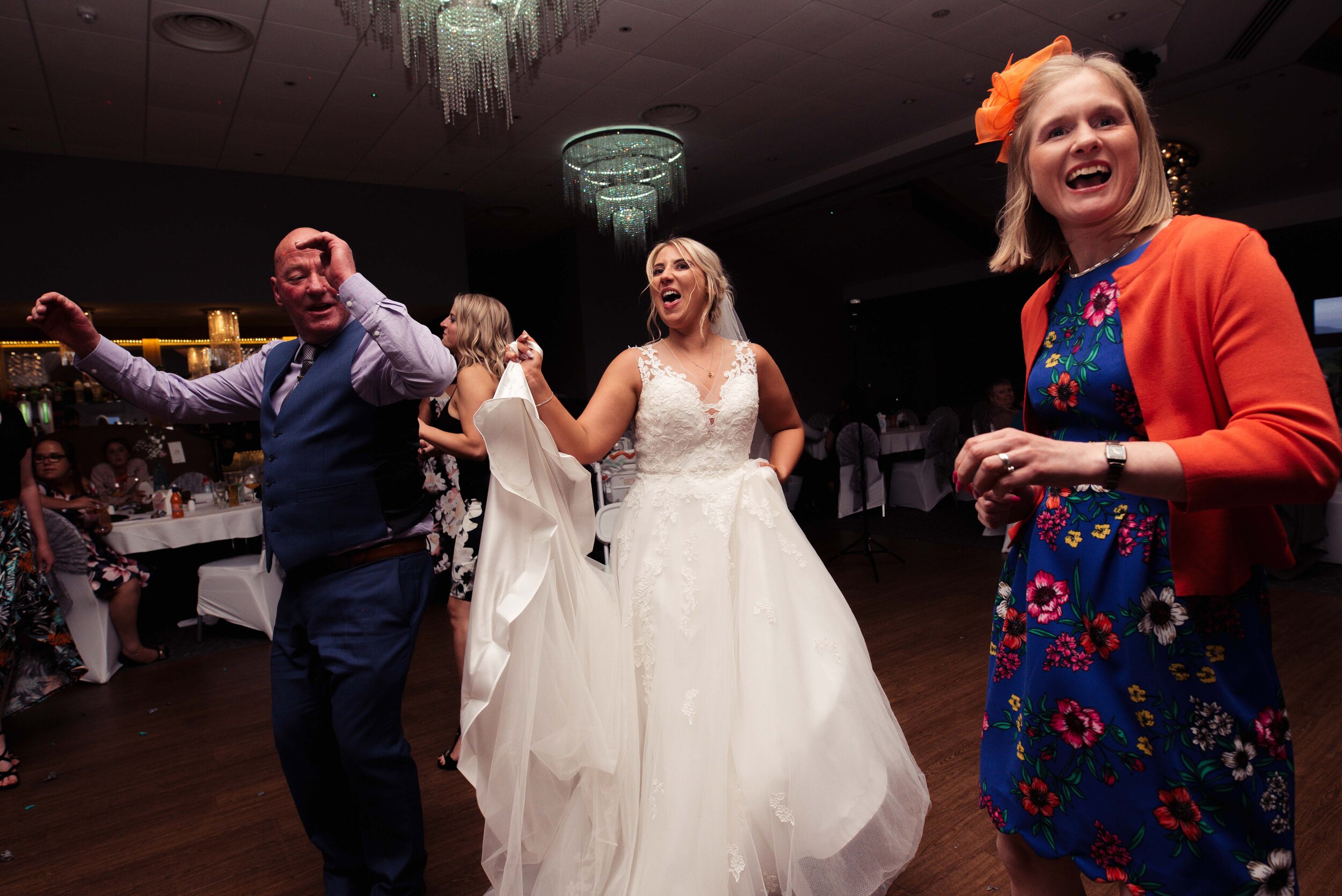 The bride dances with her guests on the dance floor