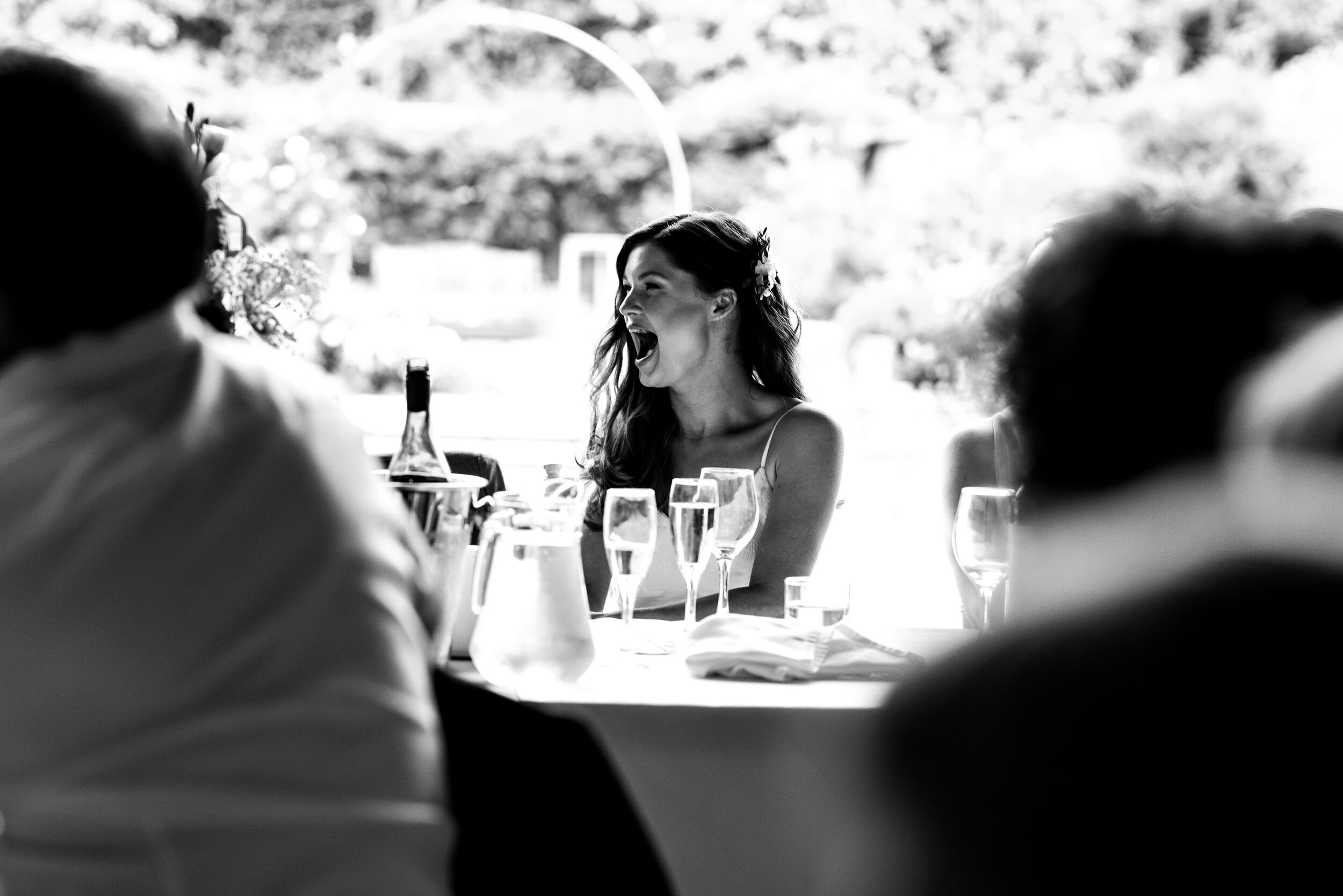 The bride laughs at her grooms speech