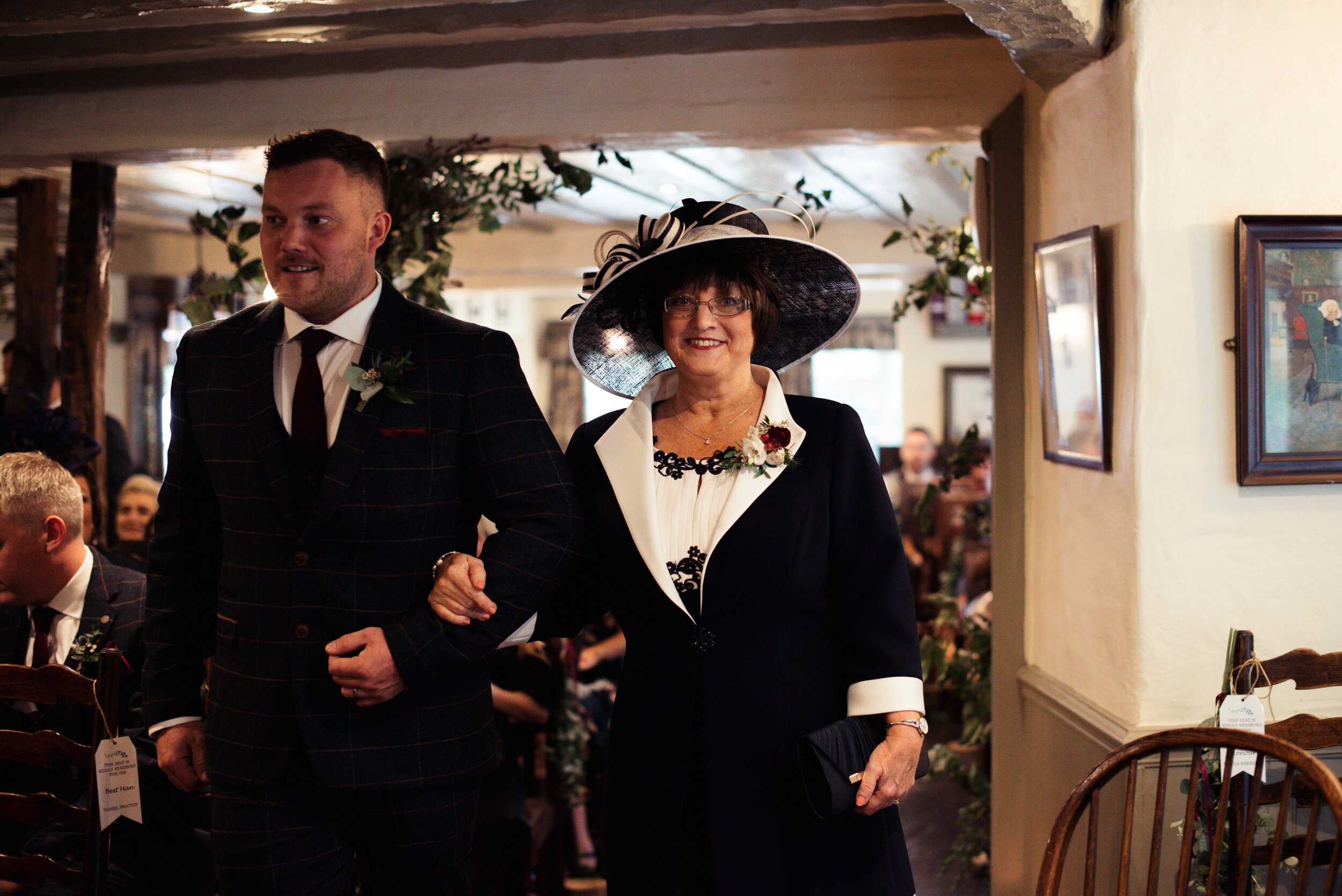 The best man escorts the brides mother up the aisle