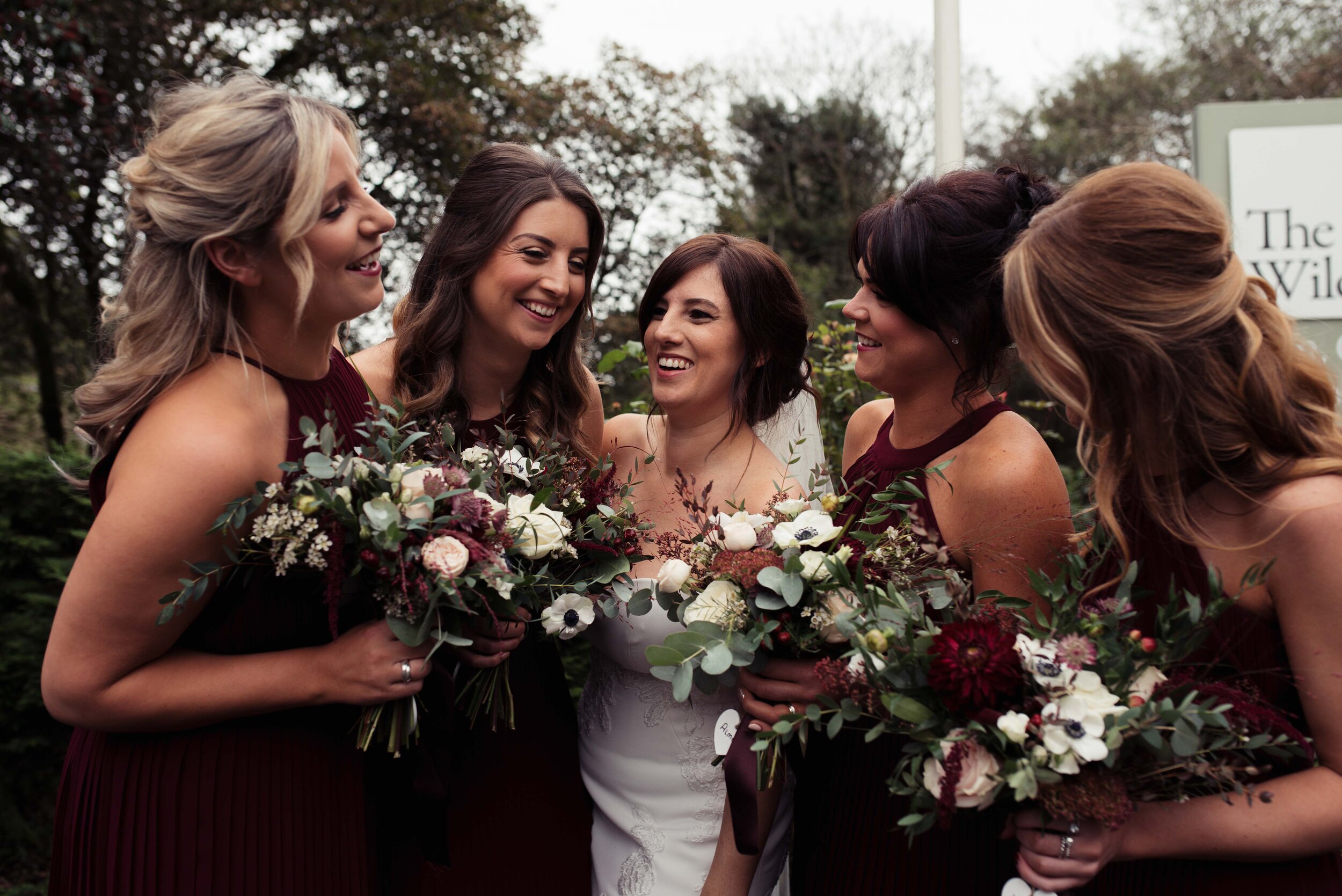 Bridesmaids and bride gather together outside the Wild Boar