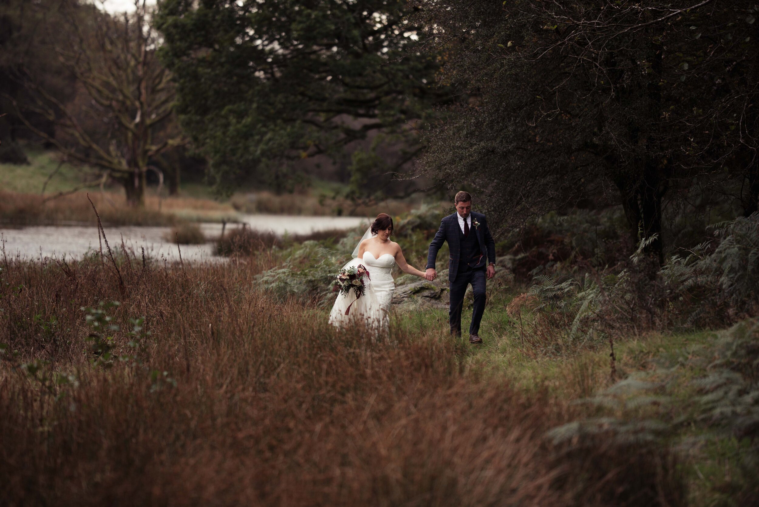 bride and groom tramping through the wilds at the wild boar