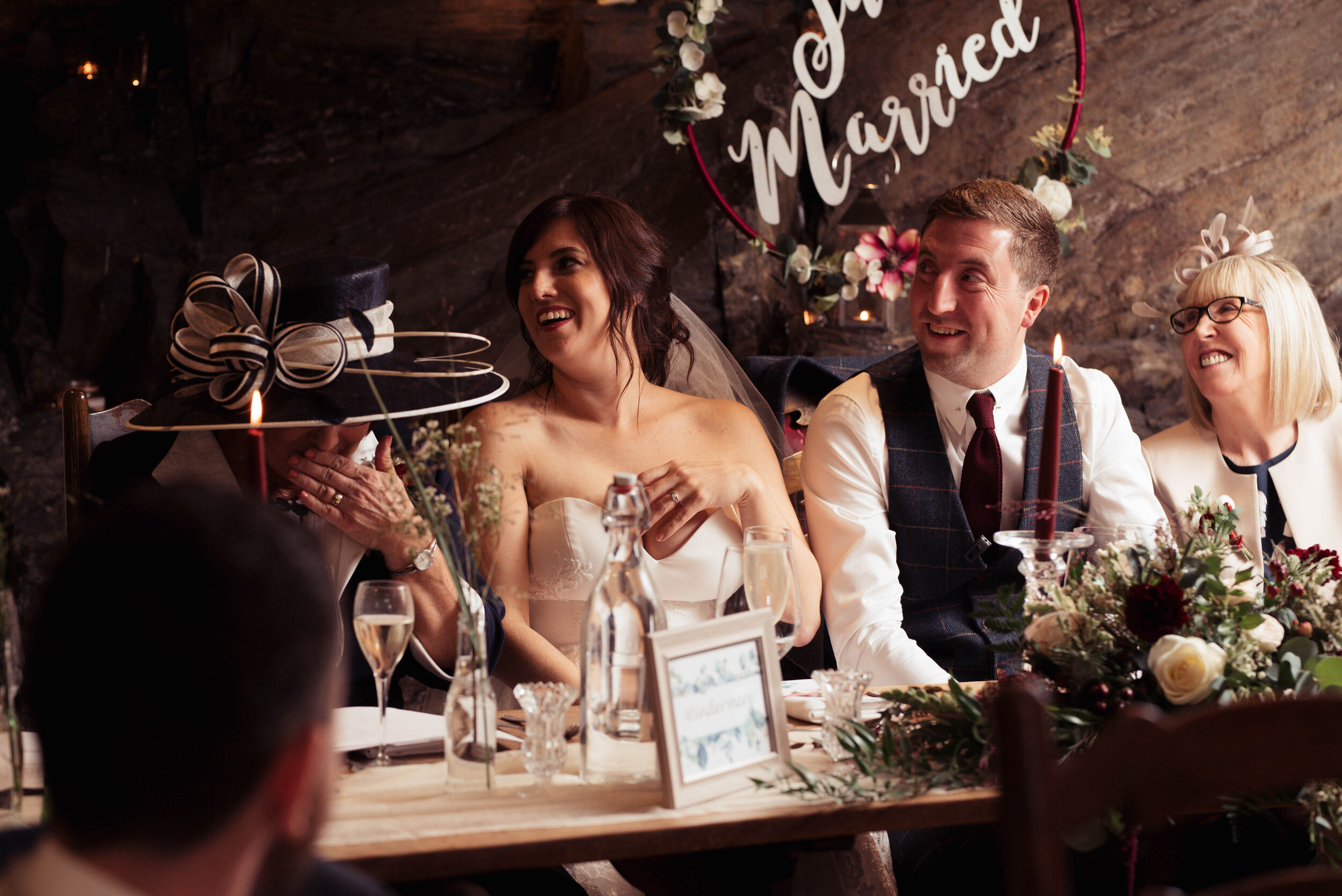 Bride and groom laughing during the speeches