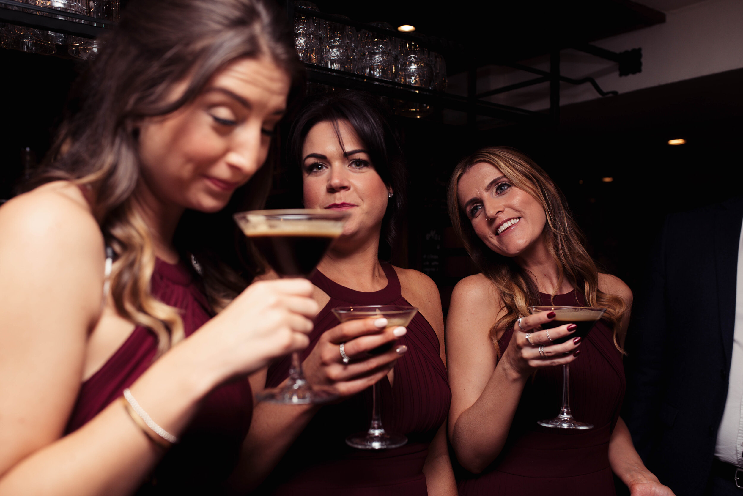 Bridesmaids share a cocktail in the bar