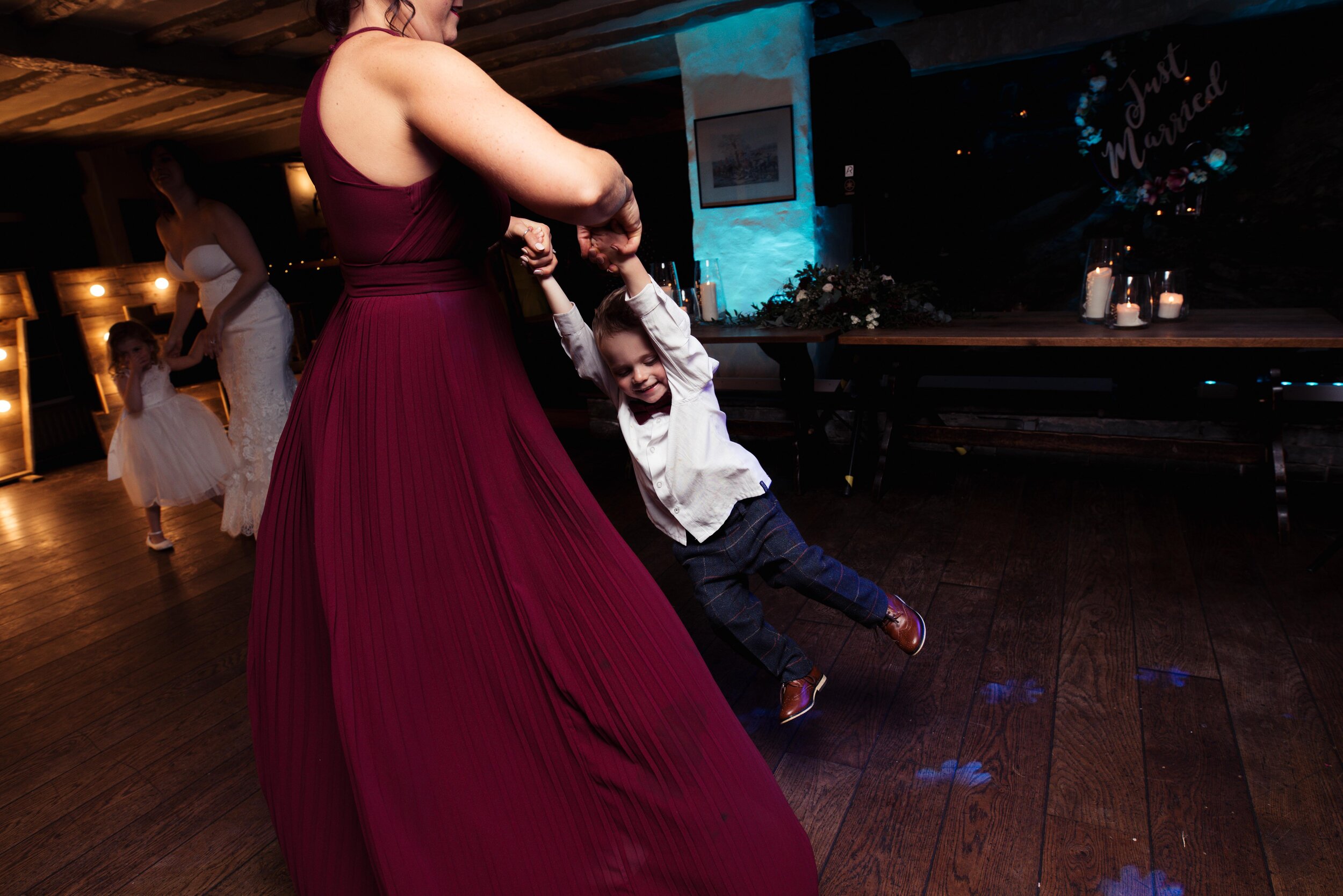 bridesmaid spinning her son around the dance floor