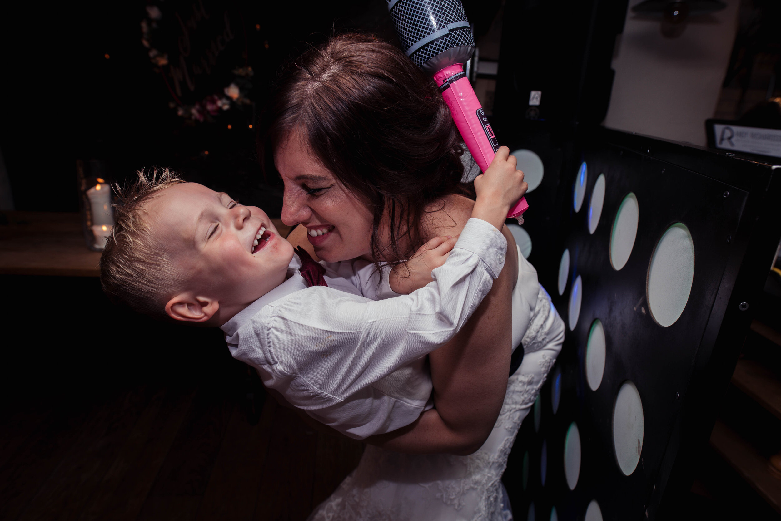 The bride and her nephew on the dance floor with an inflatable microphone