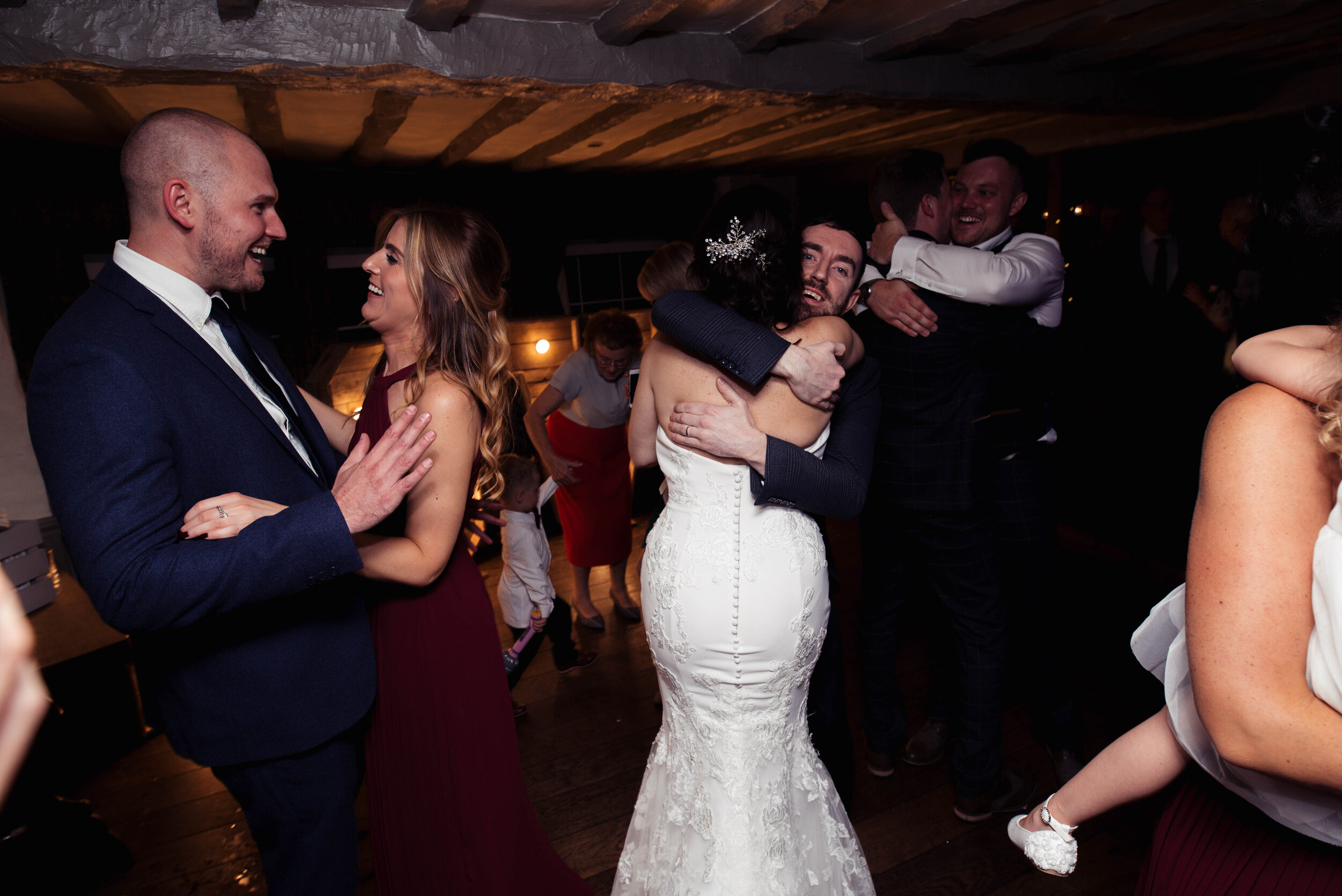 bride and groom dancing with all their family and friends