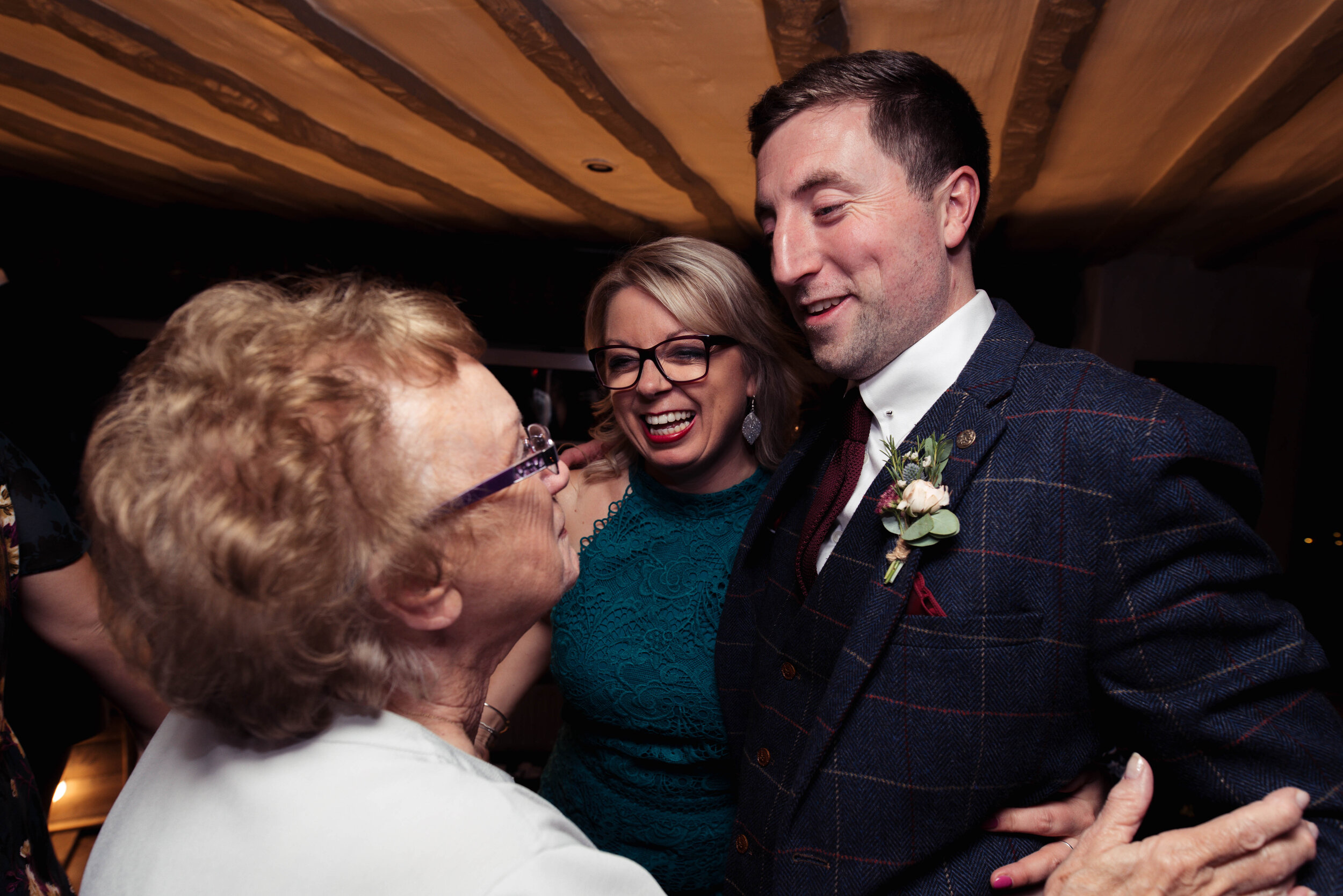 Groom goes to kiss an older relative on the dance floor