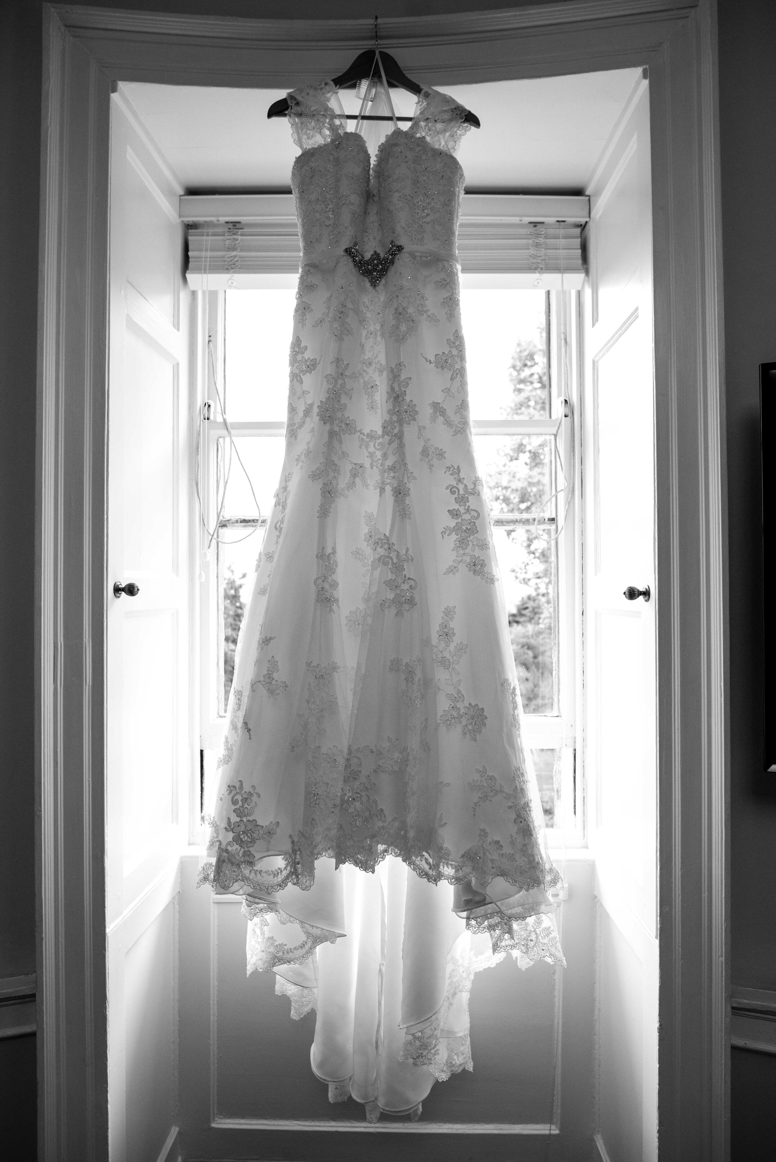 Brides dress hanging in the window