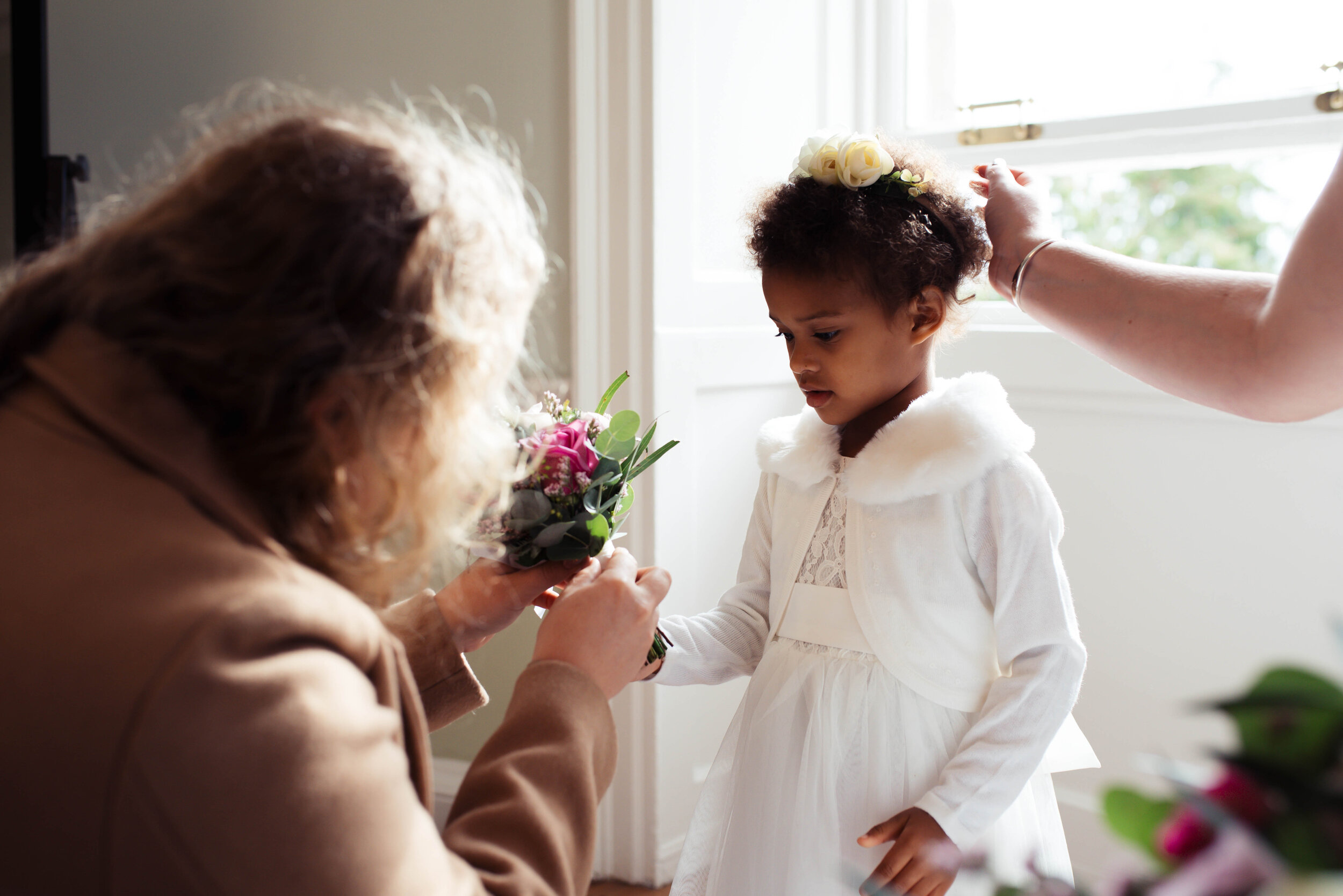 Flower girl gets given her bouquet