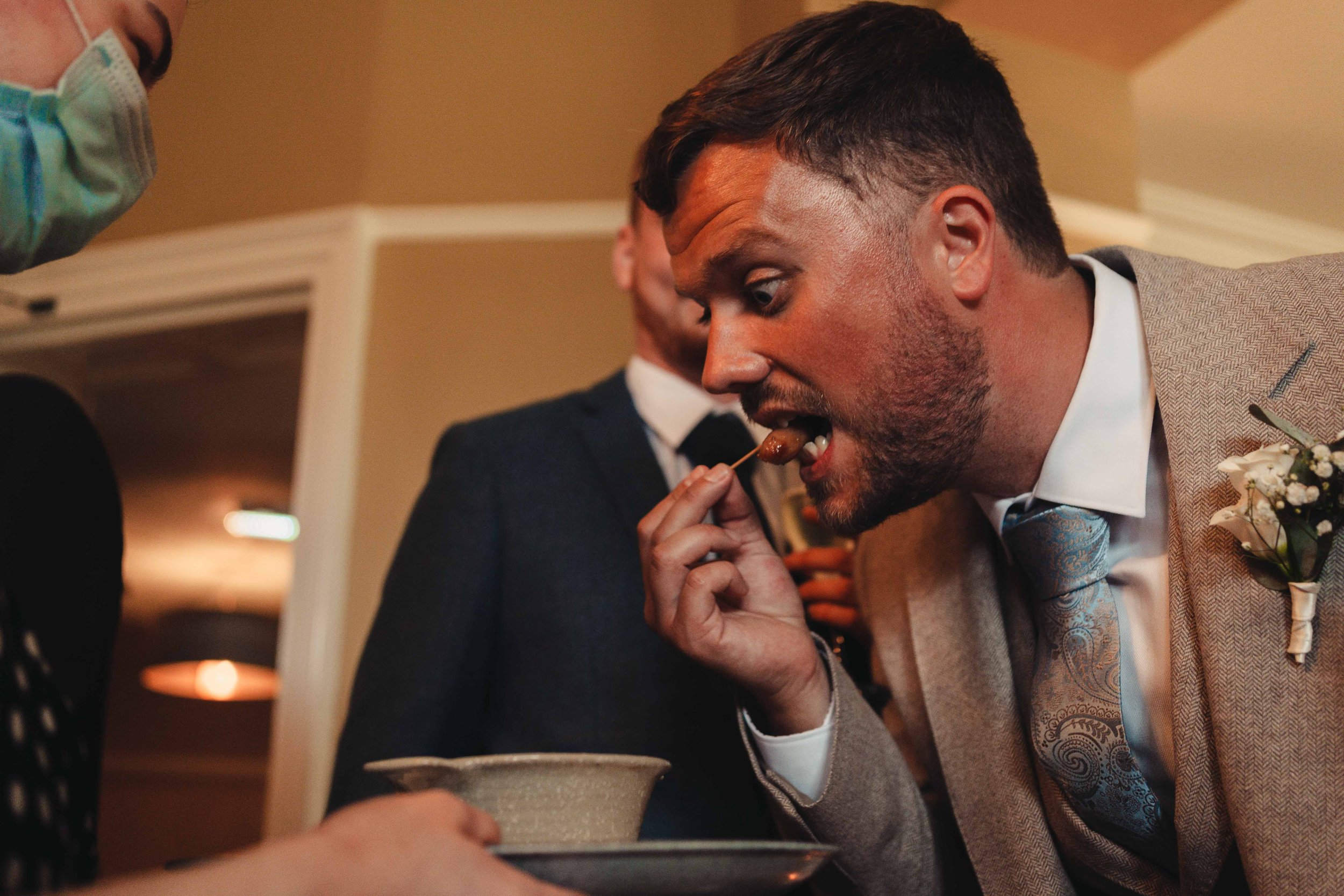 Groom eating a canapes