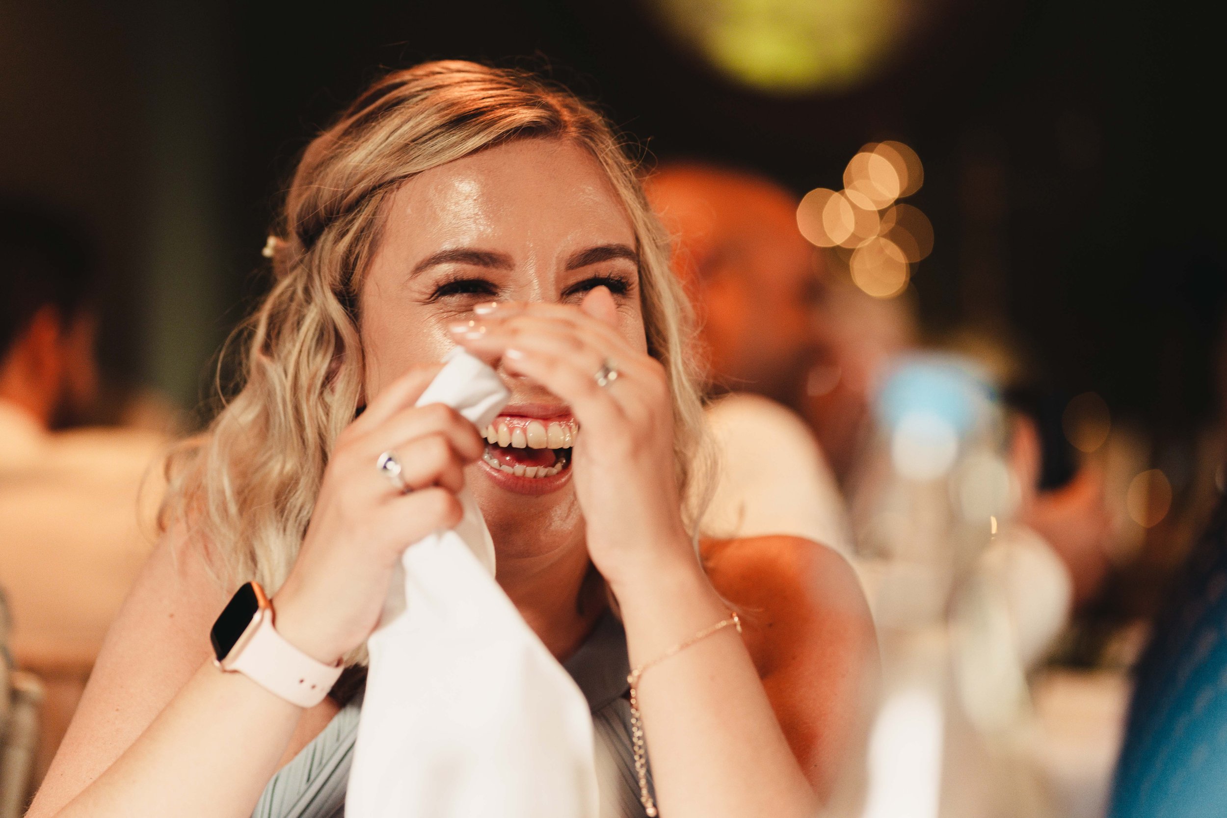 Wedding guest laughing during the speeches