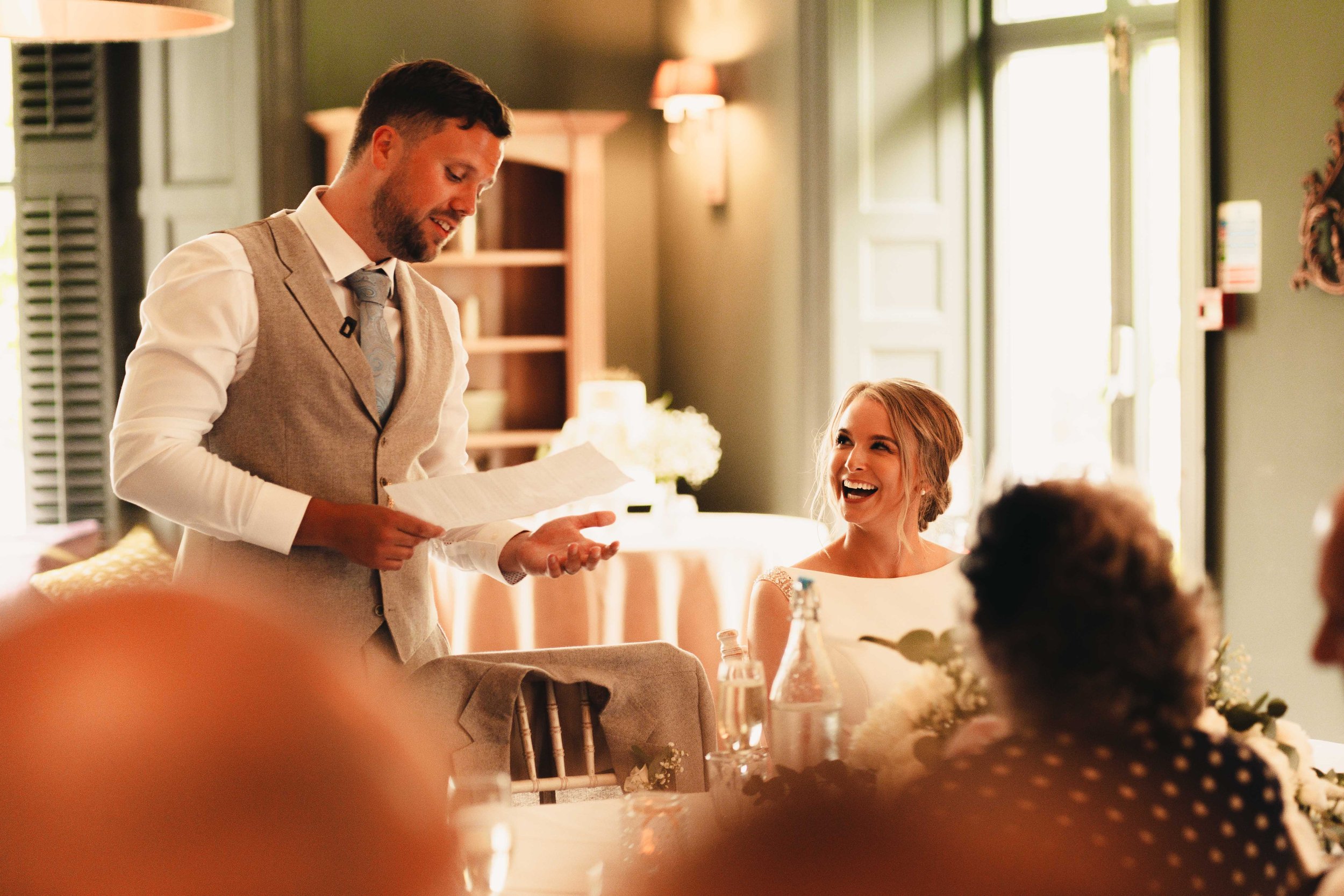 Groom jokes to the bride during his speech