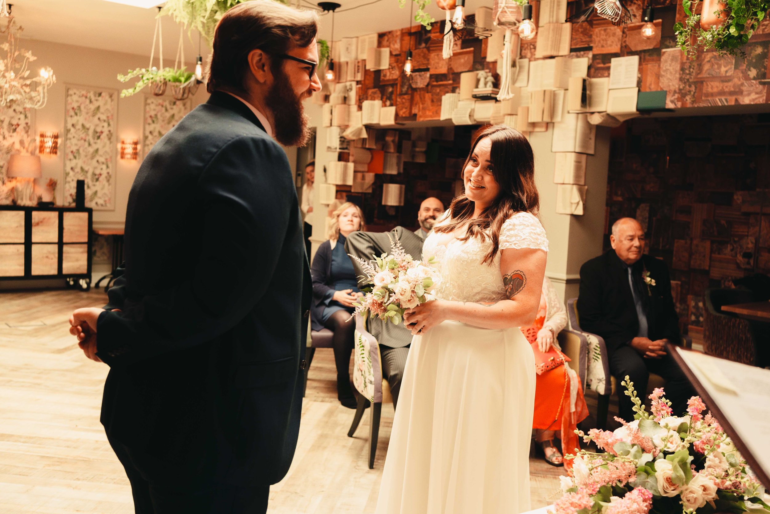 Cheeky grins between the bride and the groom in their wedding ceremony