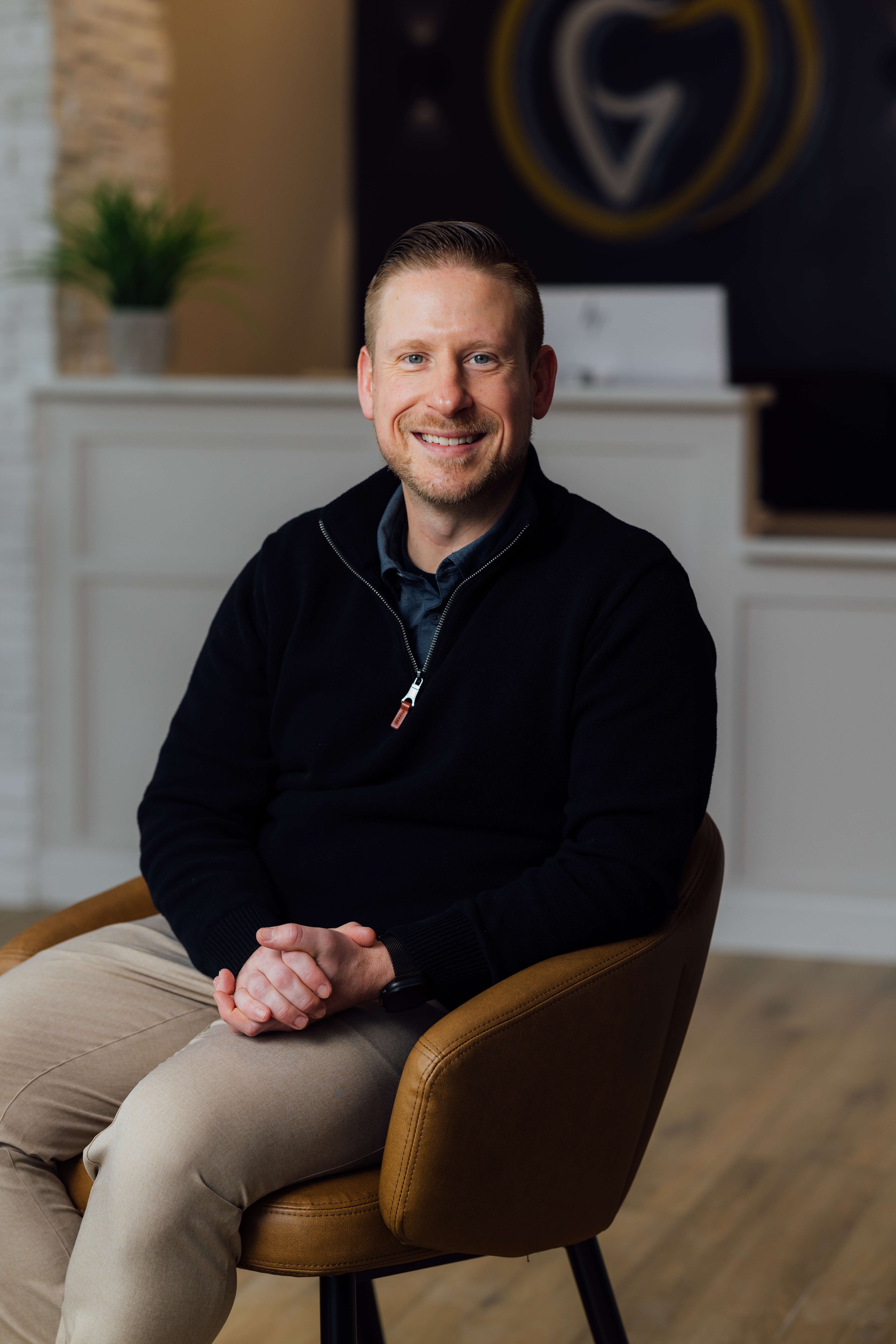 Dr. Orhan Suljic sitting in his Grimes Dental Group office