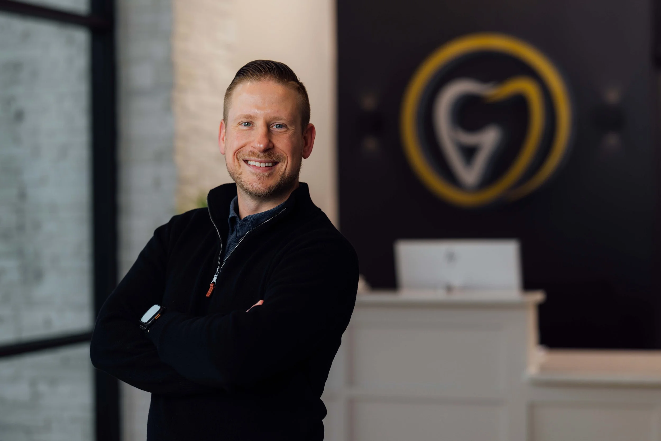 Dr. Orhan Suljic smiling in his Grimes dental lobby