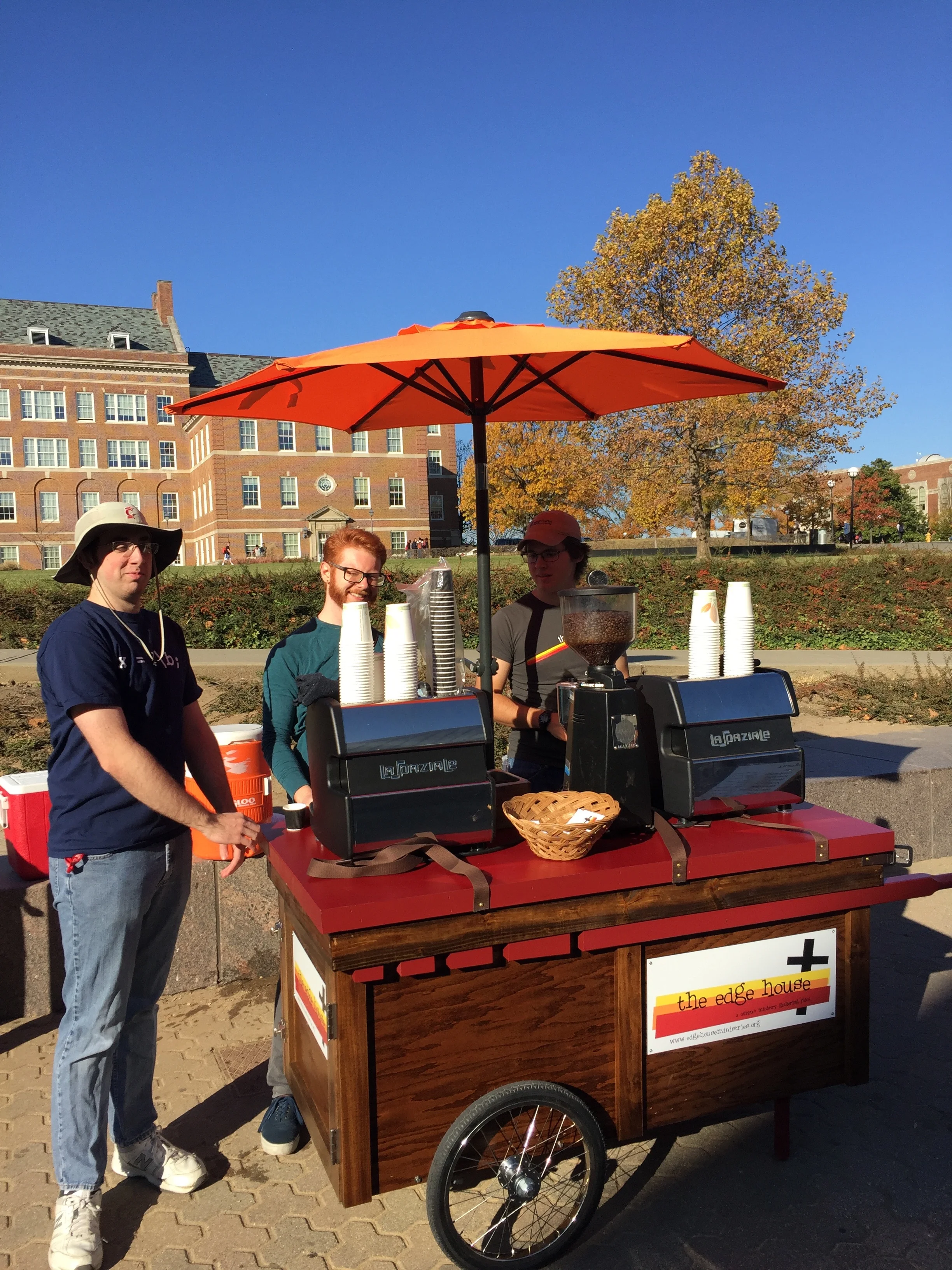 Seth, Ben, and Andrew giving away coffee. Cart designed and built by Andrew and Tres Kutcher. Photo by Alice Connor.