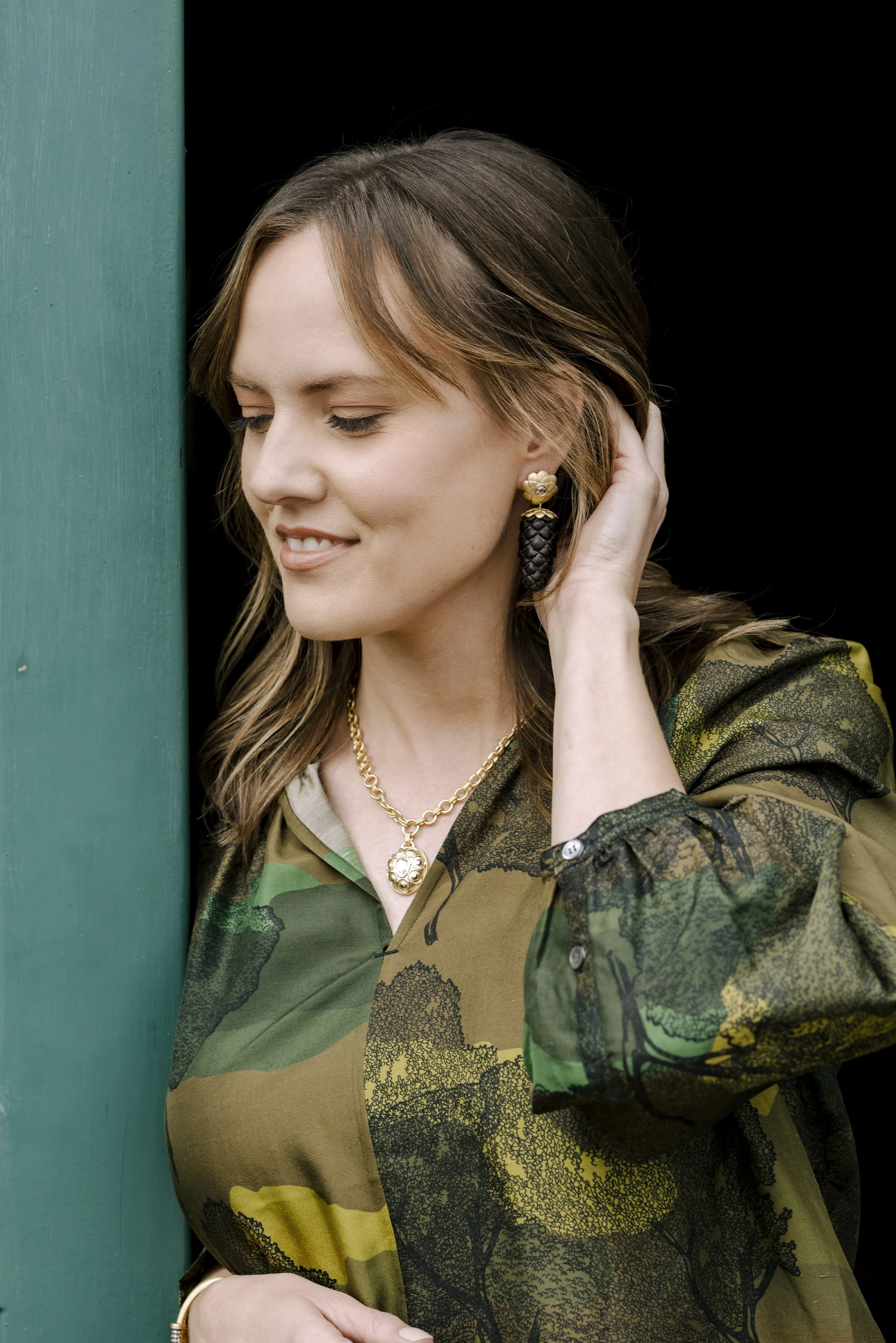 model wearing Leigh maxwell hand carved ebony pinecone earrings with rose cut Champagne diamonds in 18 karat yellow gold