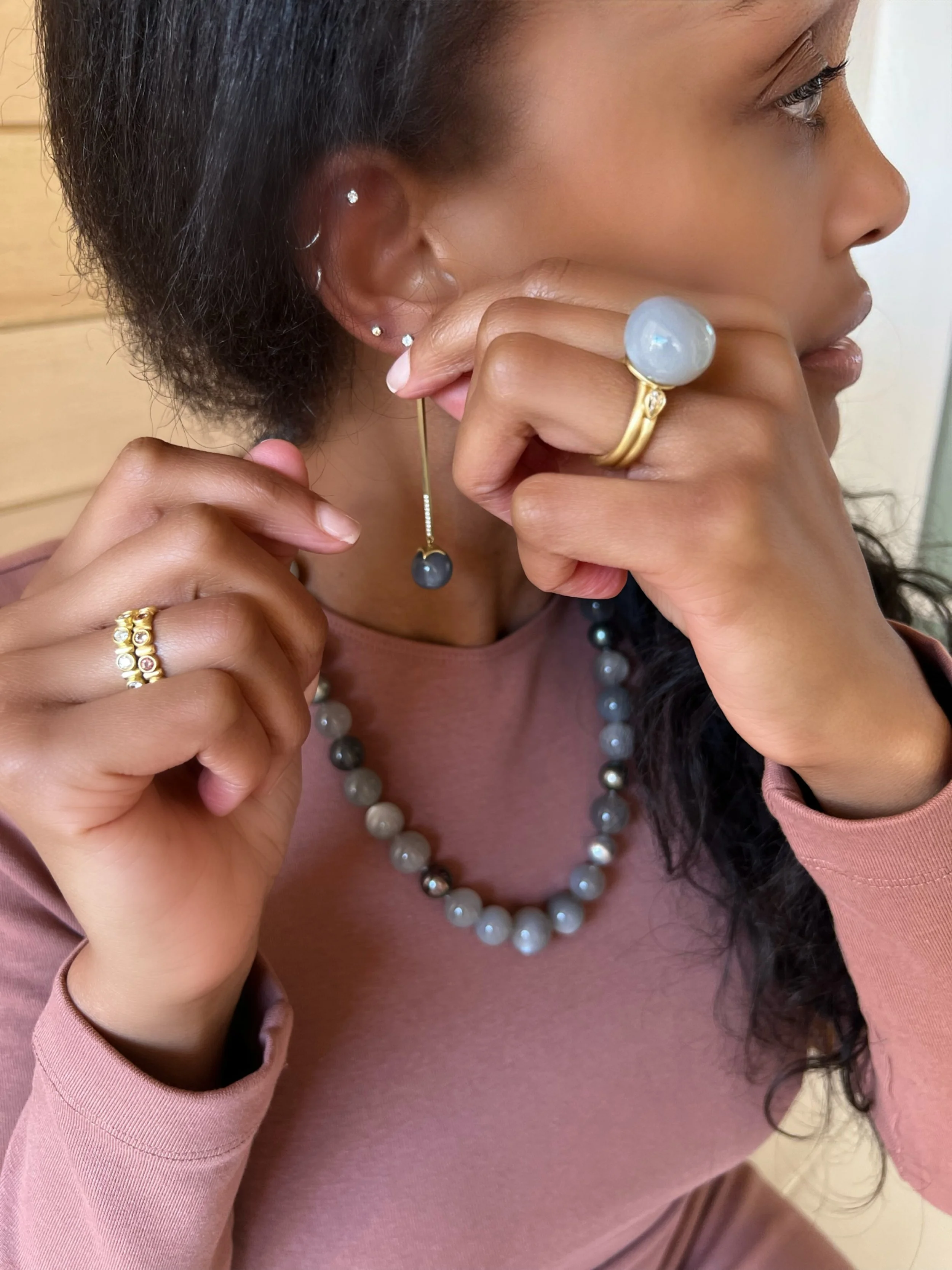 Model wearing Leigh Maxwell Ulaini eternity band in Malaia garnet