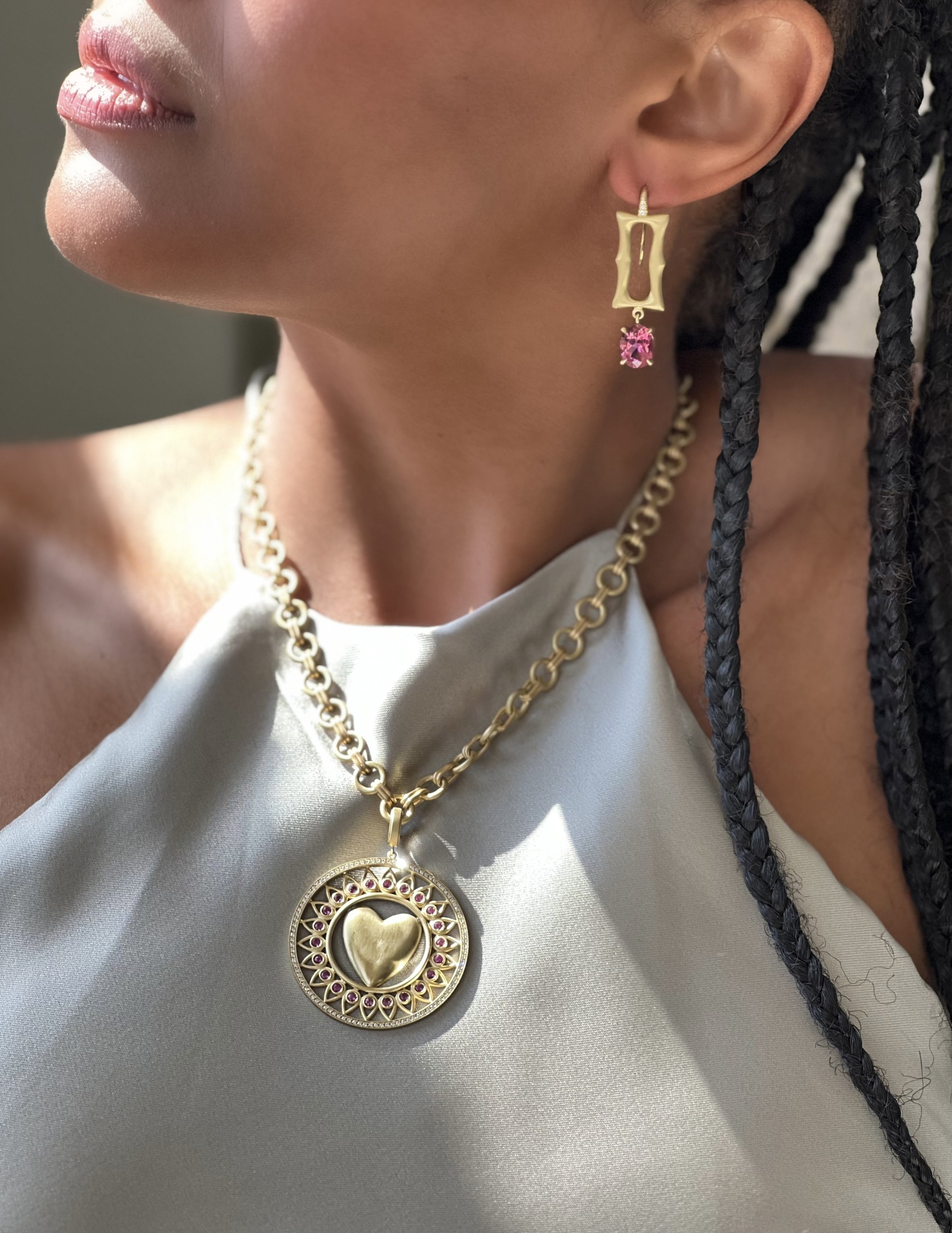 model wearing Leigh Maxwell heart medallion pendant with pink sapphires
