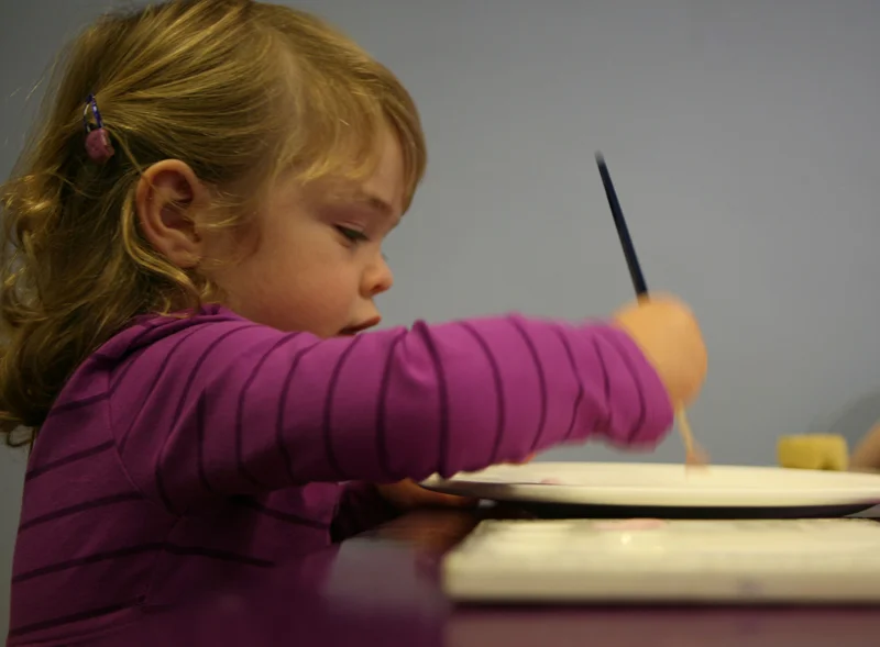 Girl painting plate.jpg