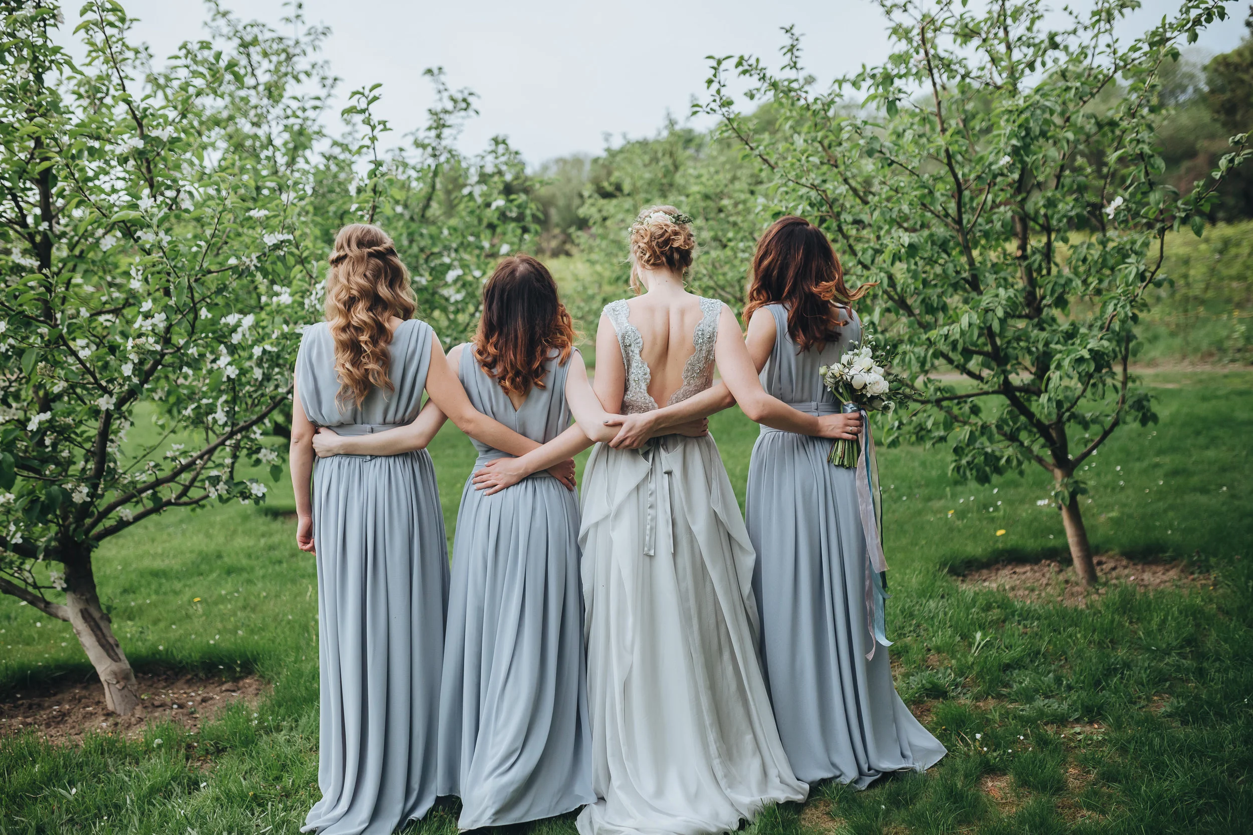 A bride hugging her bridesmaids.