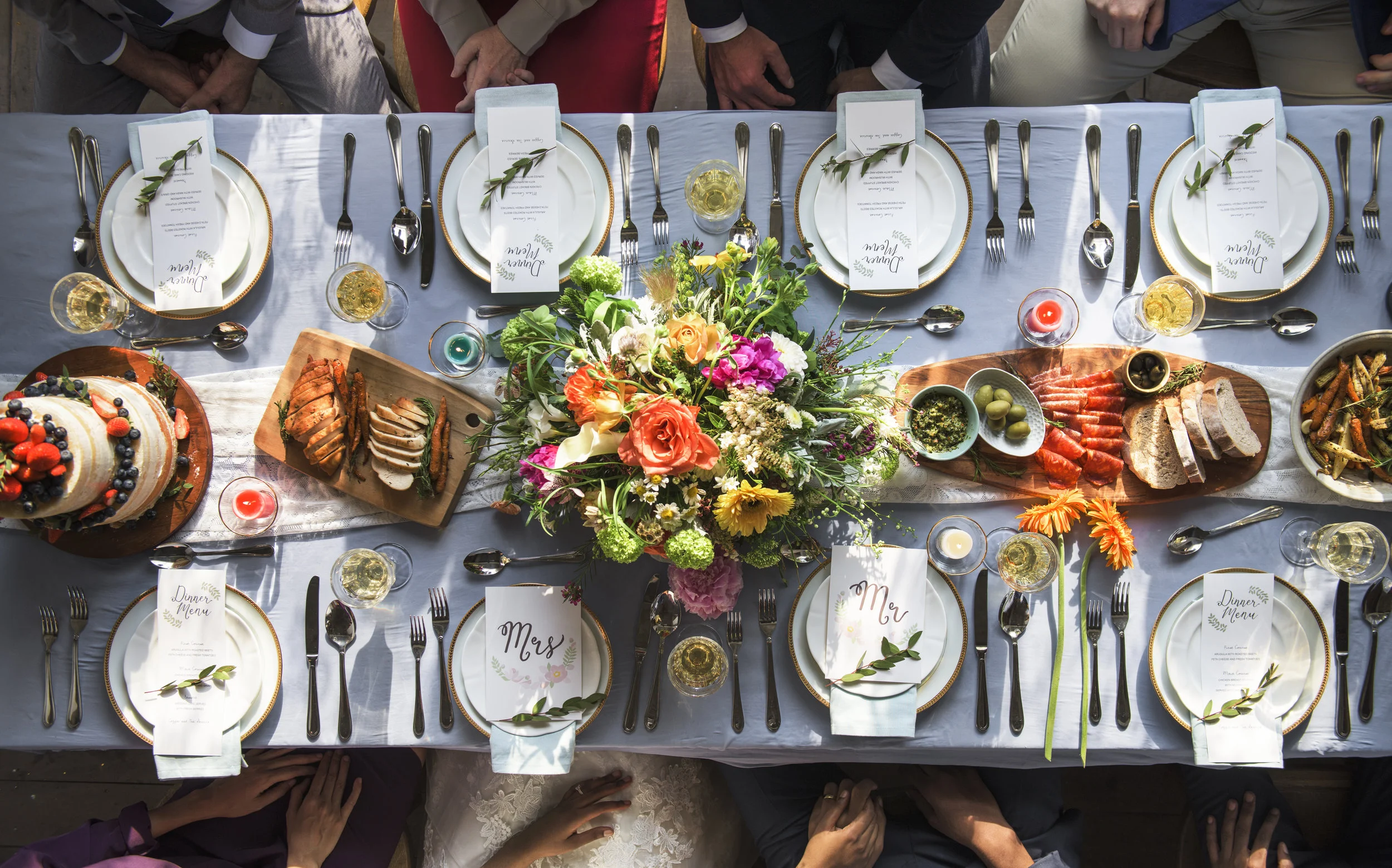 A long reception table at an outdoor wedding.