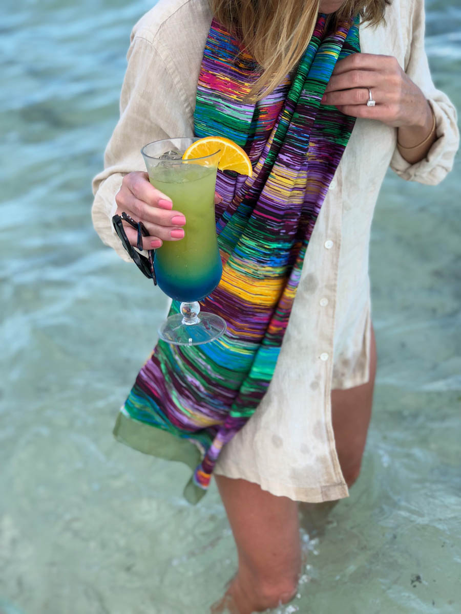 Ashley modeling silk scarf with a cool beverage in hand