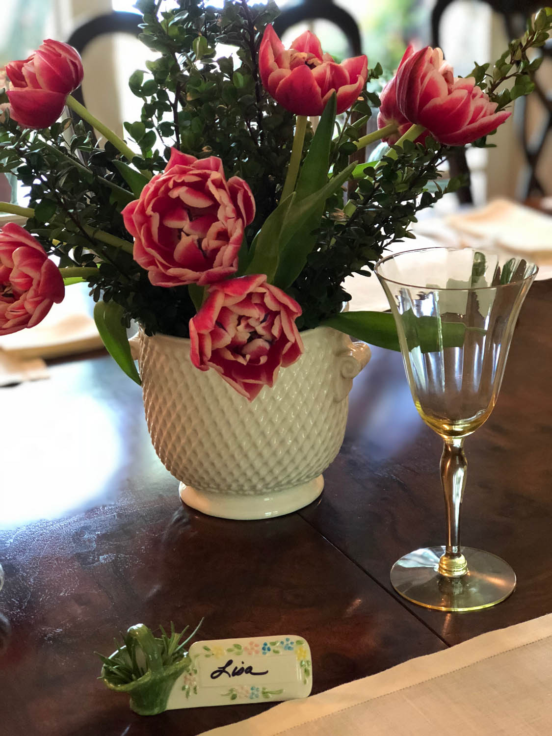 Tulip and boxwood arrangement and vintage place marker