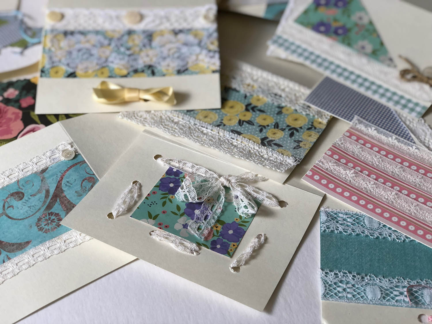 assortment of handmade cards with vintage lace and fabrics