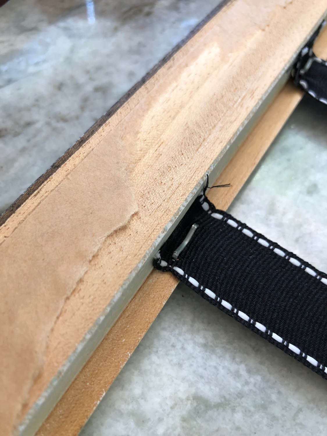 Consecutive lengths of ribbon stapled to DIY frame