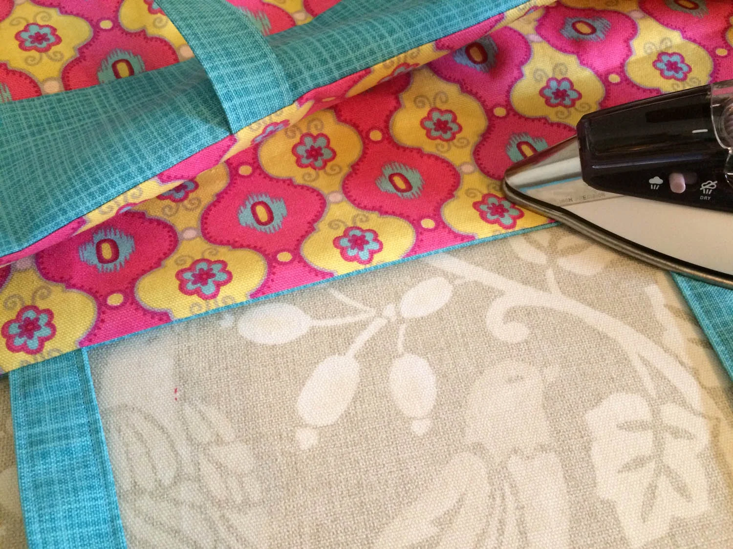 pressing the upper edge of the tote before edge stitching for a clean line