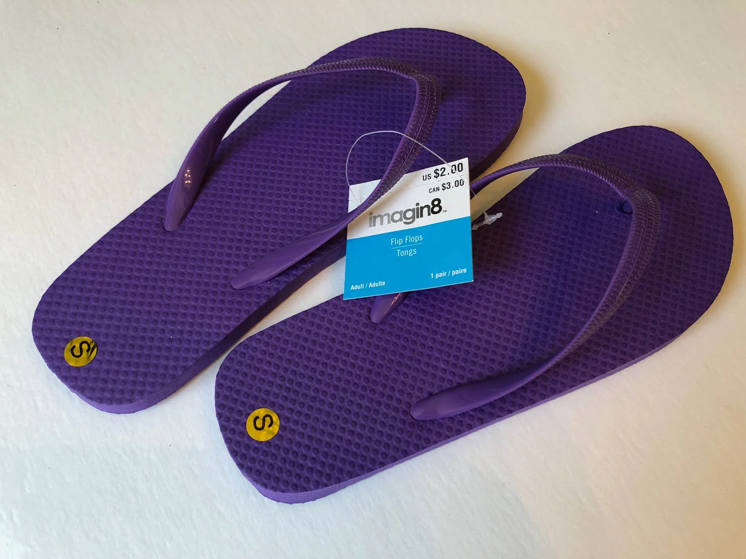 Purchased purple flip flops to embellish flip flops with silk flowers