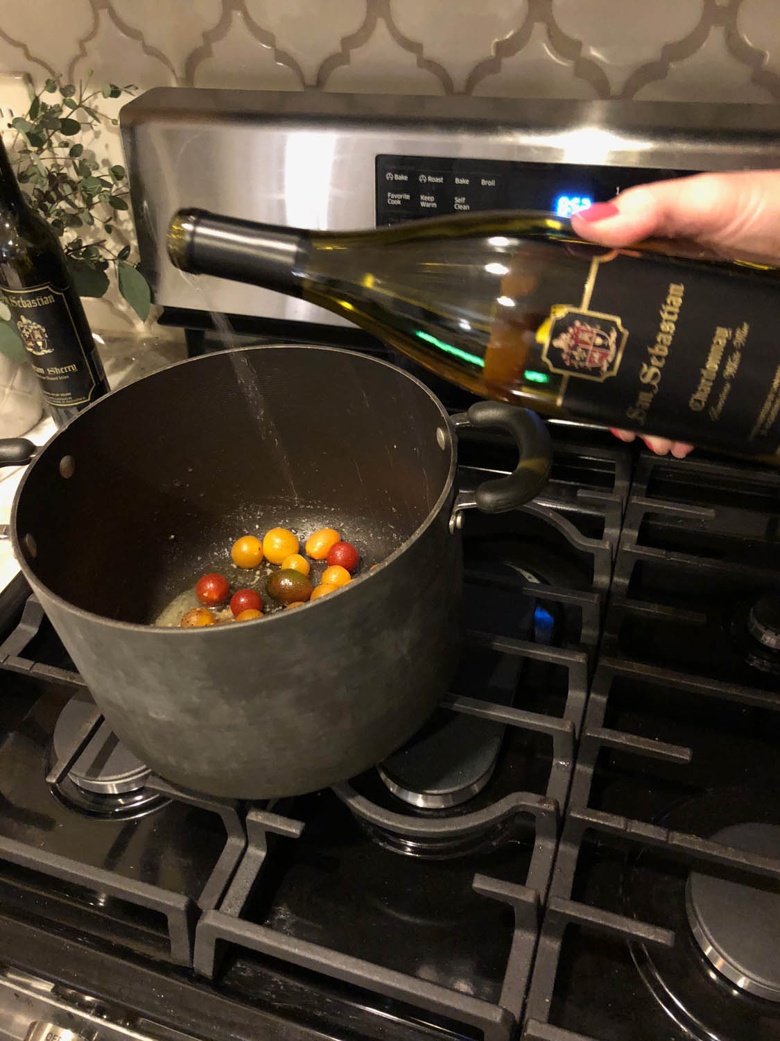 Adding wine to the pot of savory steamed mussels with tomatoes and white wine recipe.