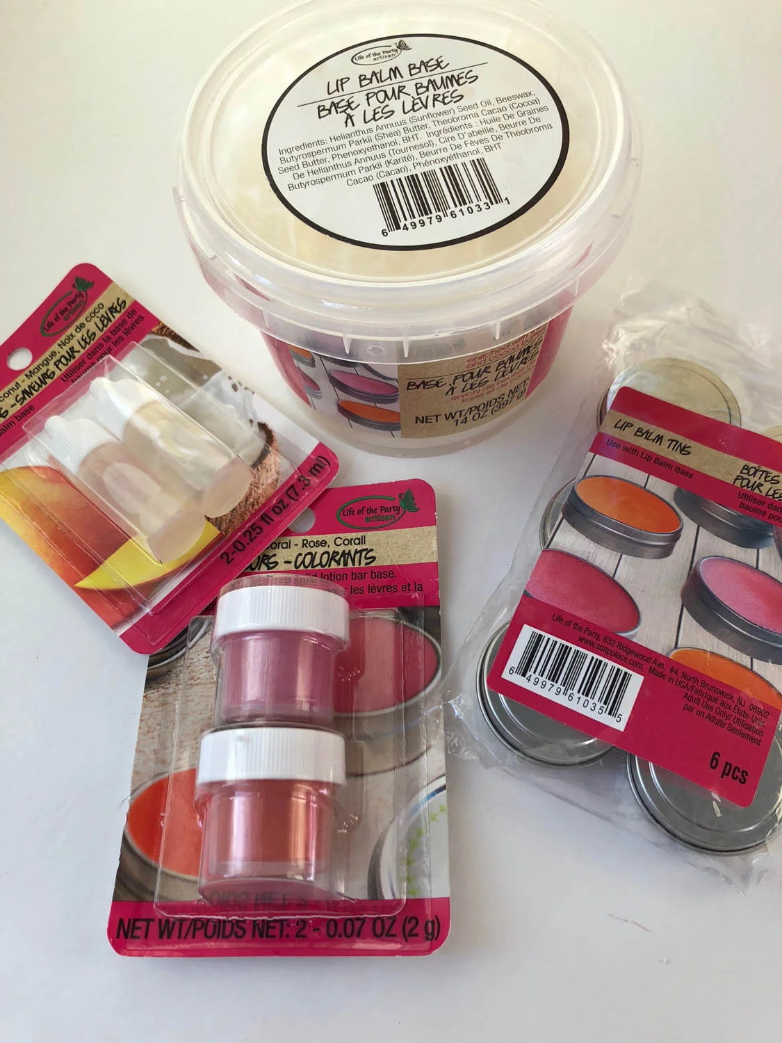Easy homemade lip balm supplies: metal tins, lip balm base, lip balm colorant, lip balm fragrance/flavoring.