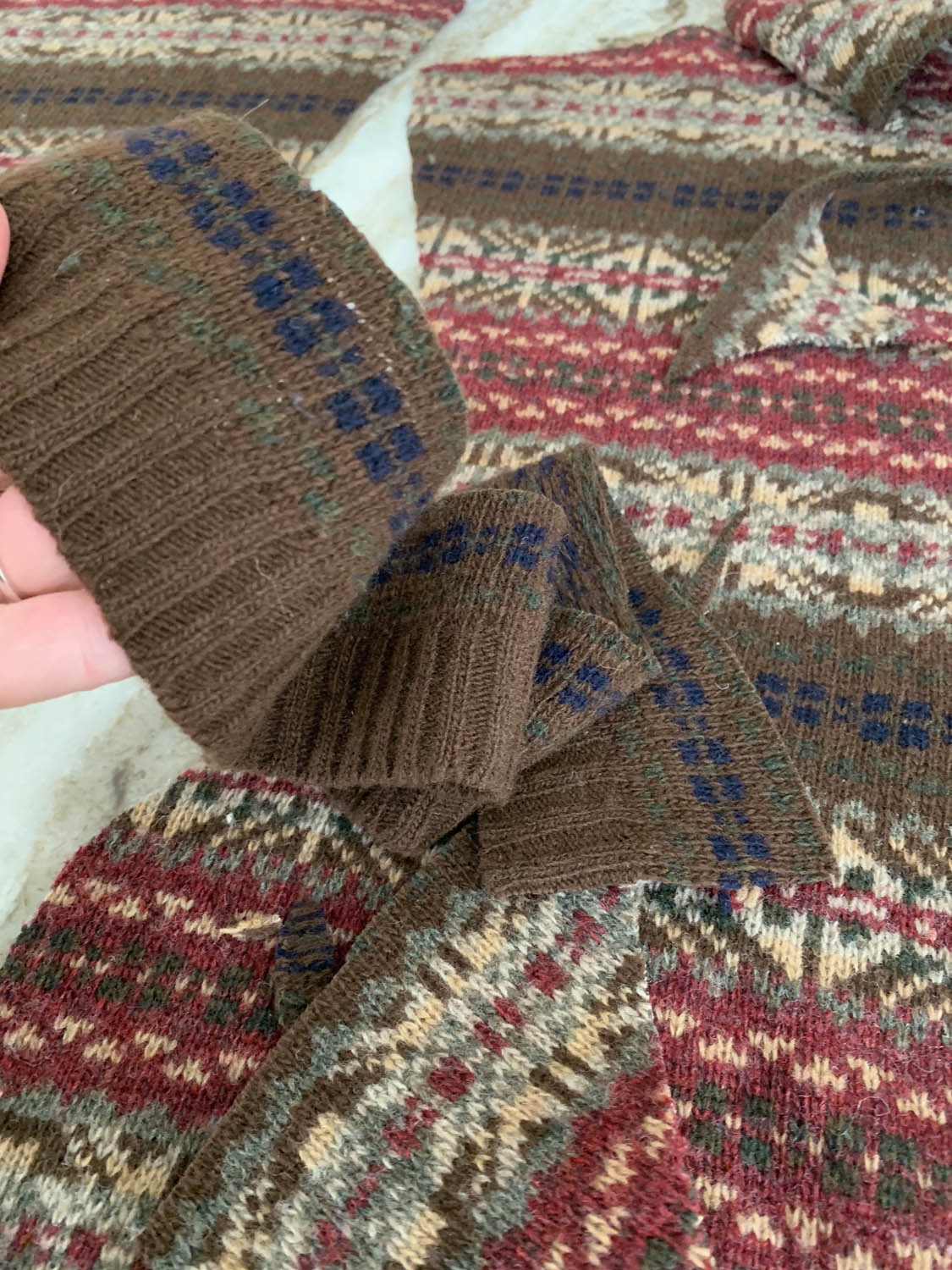 Bottom edge of sweater ribbing trimmed from thrift store sweater