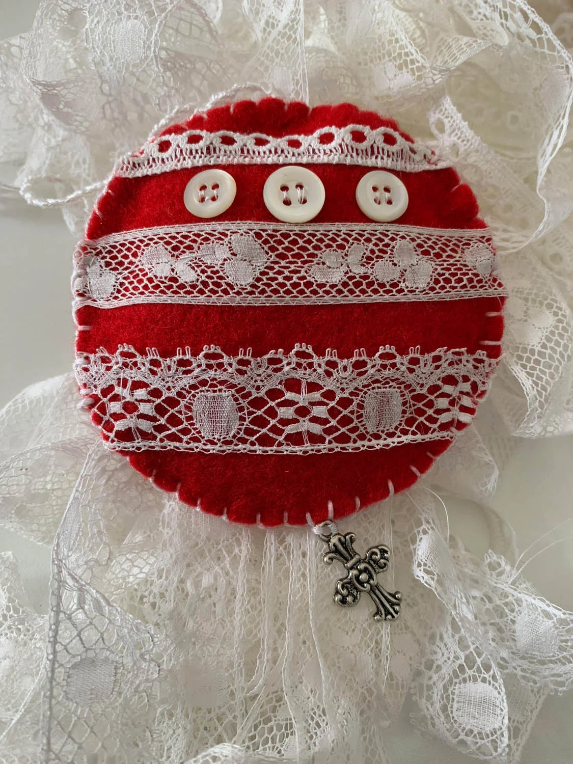 Finished hand made lace-embellished red felt Christmas ornament.