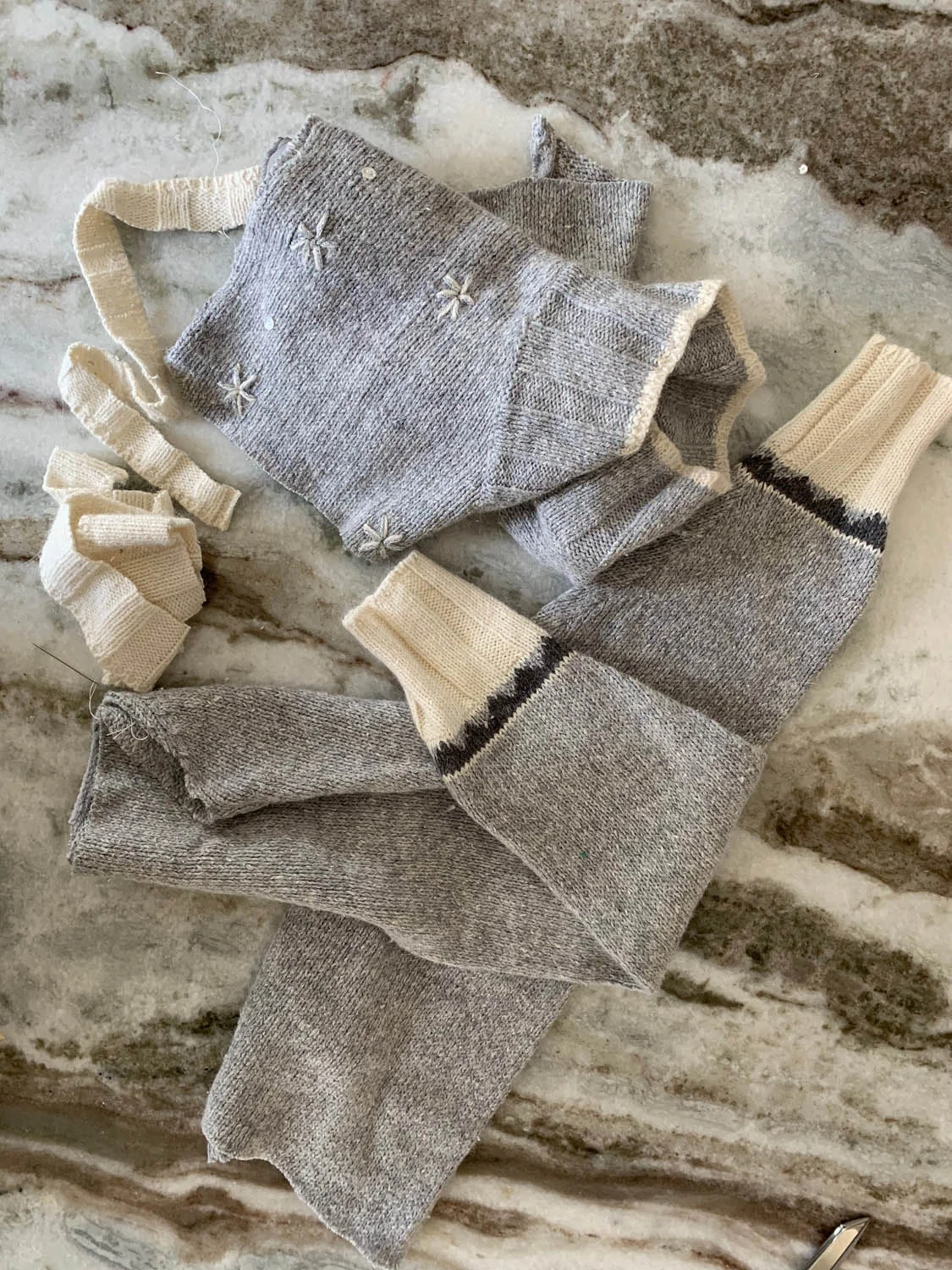 Leftover scraps from thrift store sweater after cutting out front and back for holiday pillow.