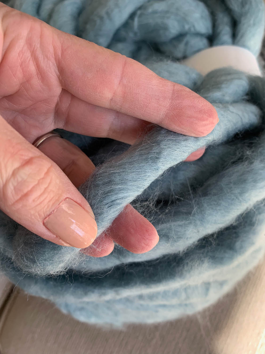 Close-up of jumbo yarn for arm-knitting technique featuring Free Spirit in dusty blue by Loops & Threads purchased at Michael’s
