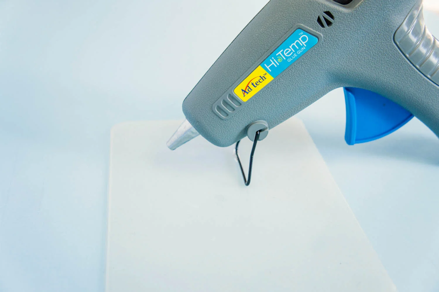 Hot glue gun upright over silicone mat