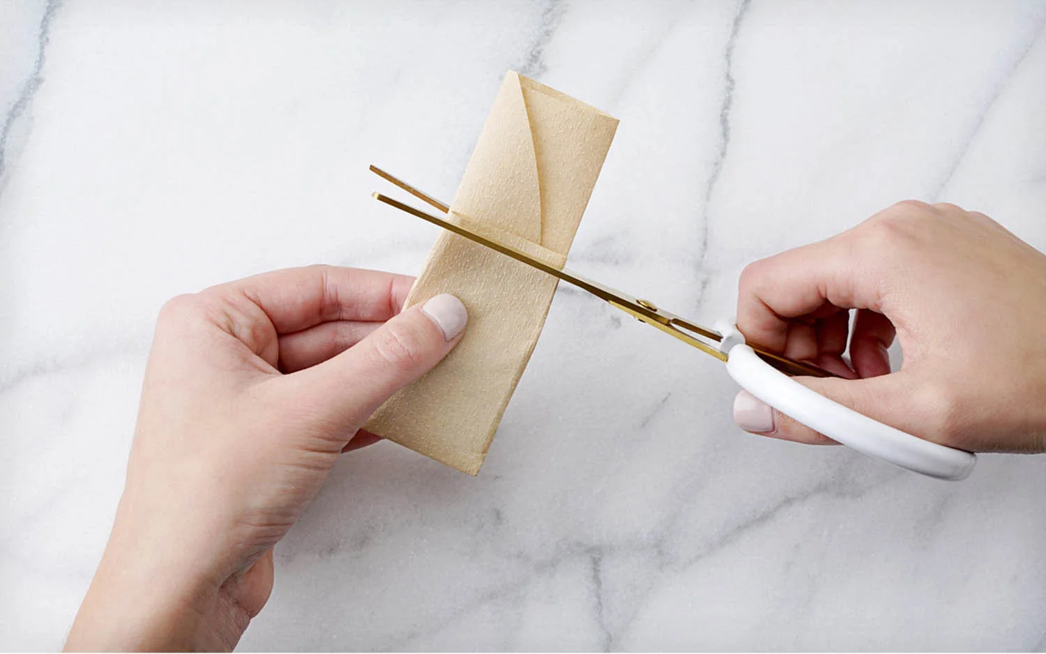 Using scissors to trim the top of the paper tea filter even before attaching the string for the print at home tea bag tag
