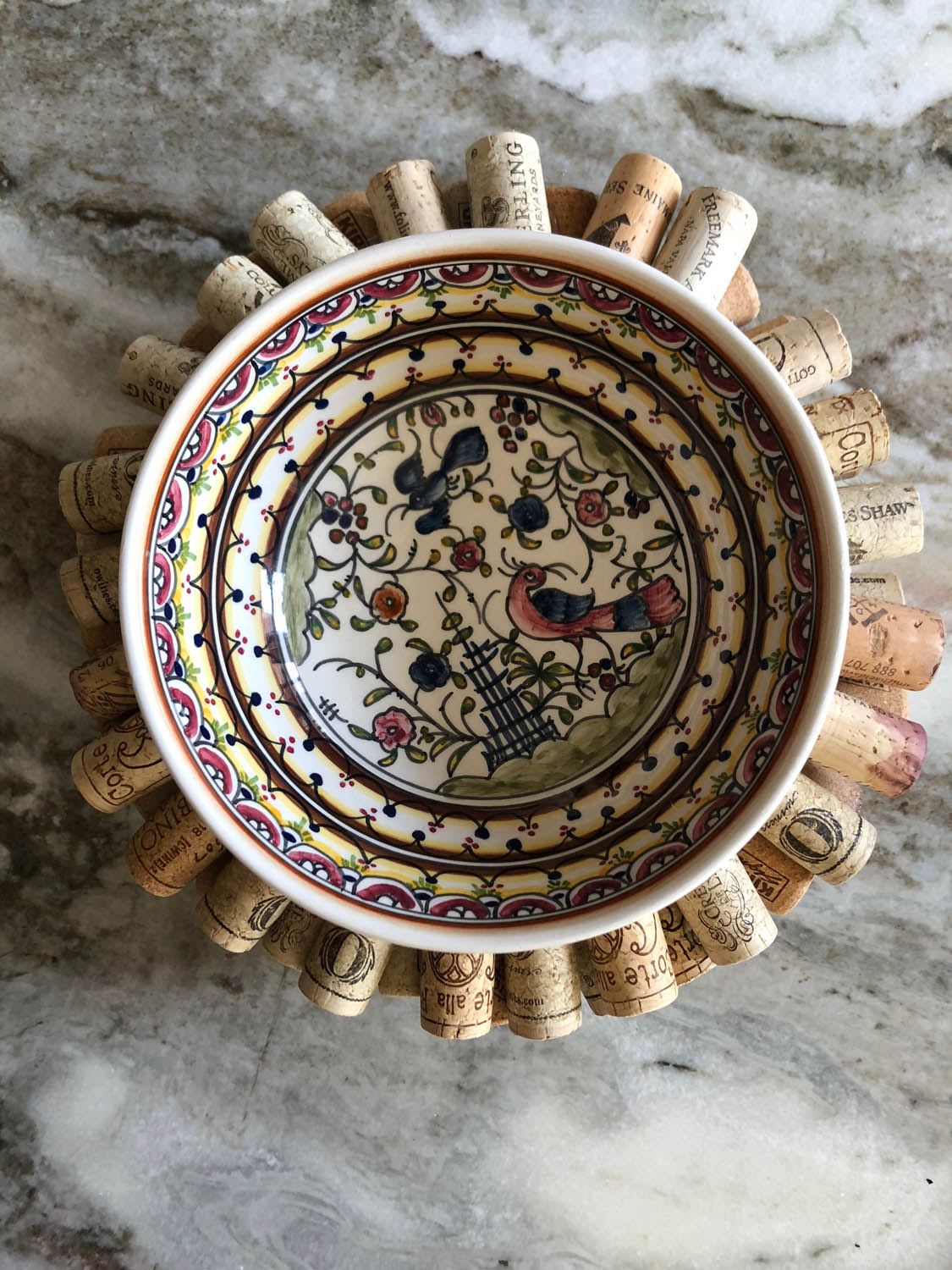 Top view of painted ceramic bowl on top of DIY upcycled wine cork trivet wreath