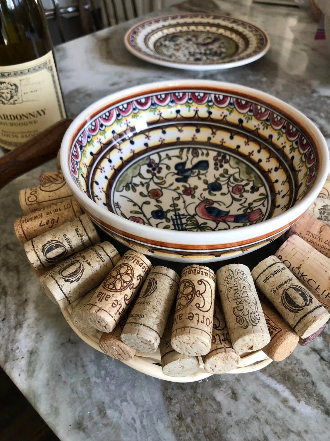 DIY upcycled wine cork wreath used as a trivet with a ceramic bowl in the center
