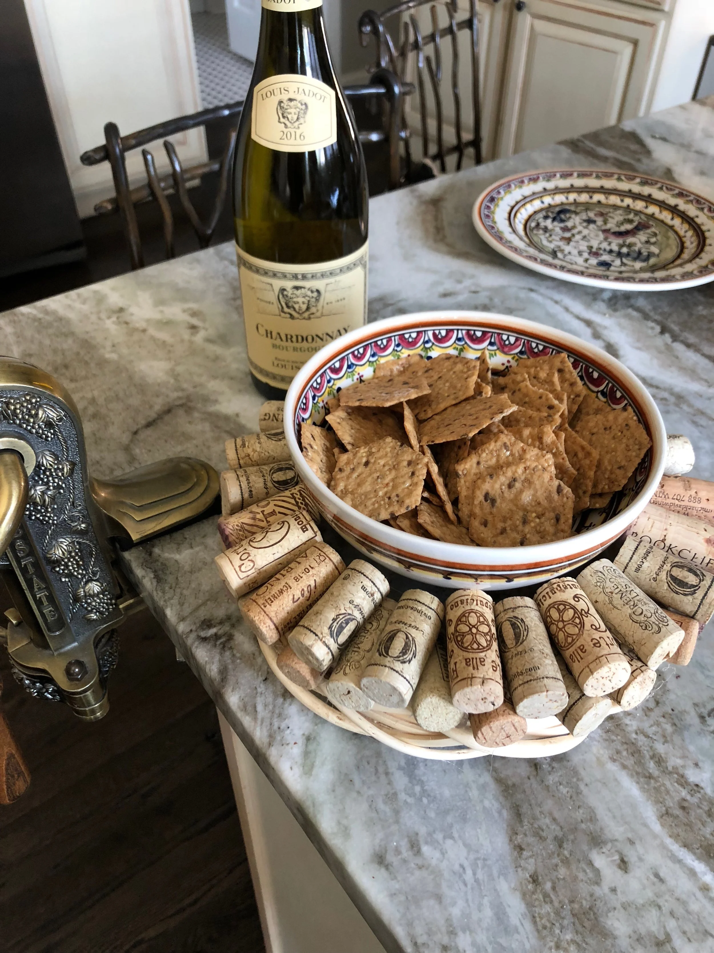 Wine cork wreath used as a trivet with ceramic bowl full of chips in the center