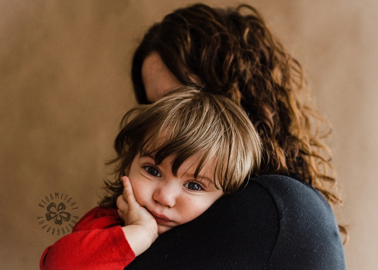 Innocent face of baby on her mom's shoulder
