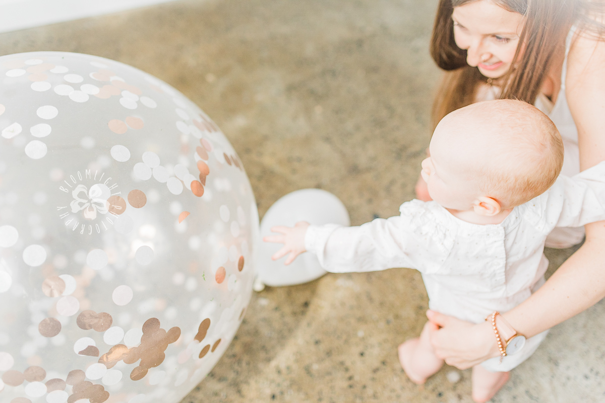 Mommy and baby playing with a big balloon