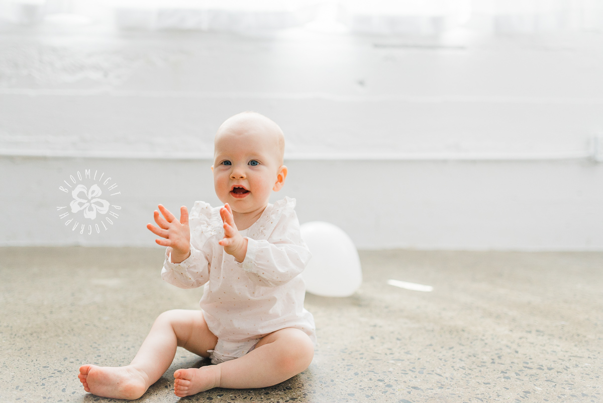 Cute baby clapping hands happily.