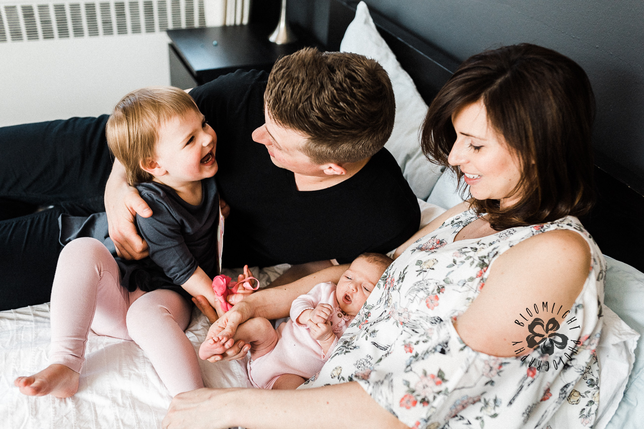 Candid family photo with a newborn and a toddler at their home in Toronto